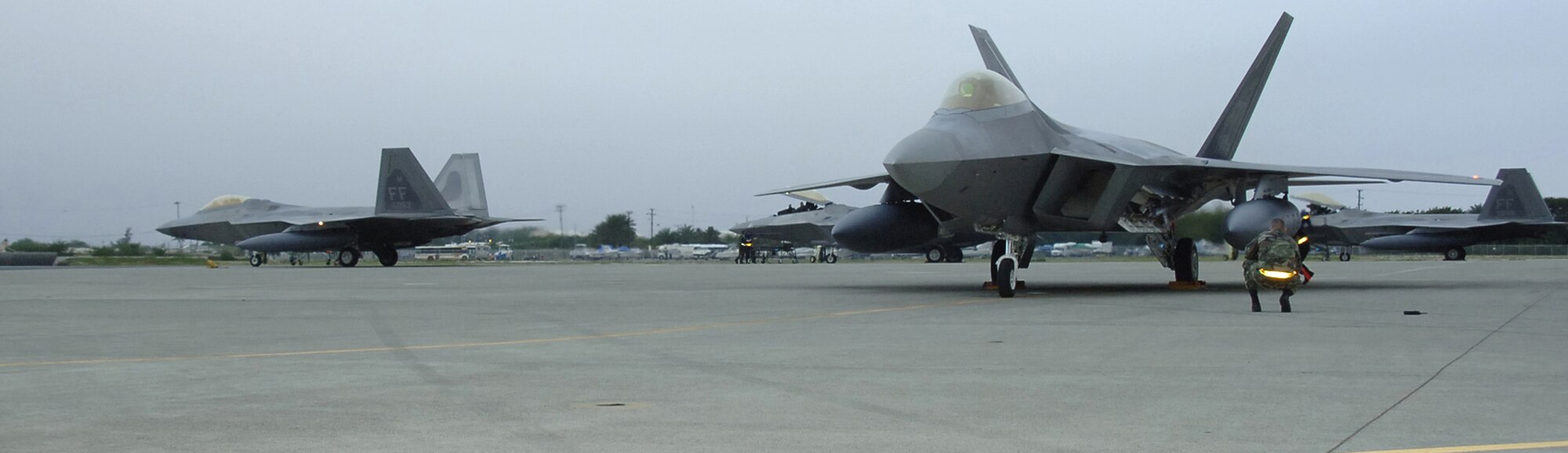 HICKAM AIR FORCE BASE, Hawaii -- The first F-22s taxi here Feb. 7, 2007, on their way to Kadena Air Base, Japan. The 27th Fighter Squadron, Langley Air Force Base, Va. are deploying 12 F-22s and more than 250 personnel overseas for the first time to Japan. (U.S. Air Force photo by Vanessa Perez) 

