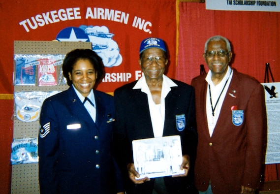 Tech. Sgt. Carla Barber poses with Tuskegee Airmen Mr. Buford A. Johnson, center, and retired Lt. Col. James H. Harvey III, at the 35th Annual Tuskegee Airmen Convention last August in Arizona.