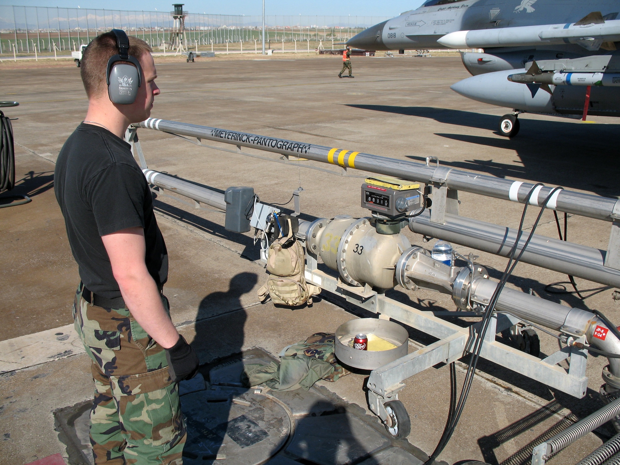 Senior Airmen Blake Mellom keeps track of how much fuel is going into an F-16 Fighting Falcon as he refuels the aircraft Feb. 7 at Incirlik Air Base, Turkey. Airman Mellom is deployed from the 52nd Logistical Readiness Squadron at Spangdahlem AB, Germany. (U.S. Air Force photo/Airman 1st Class Tom Kennedy) 
