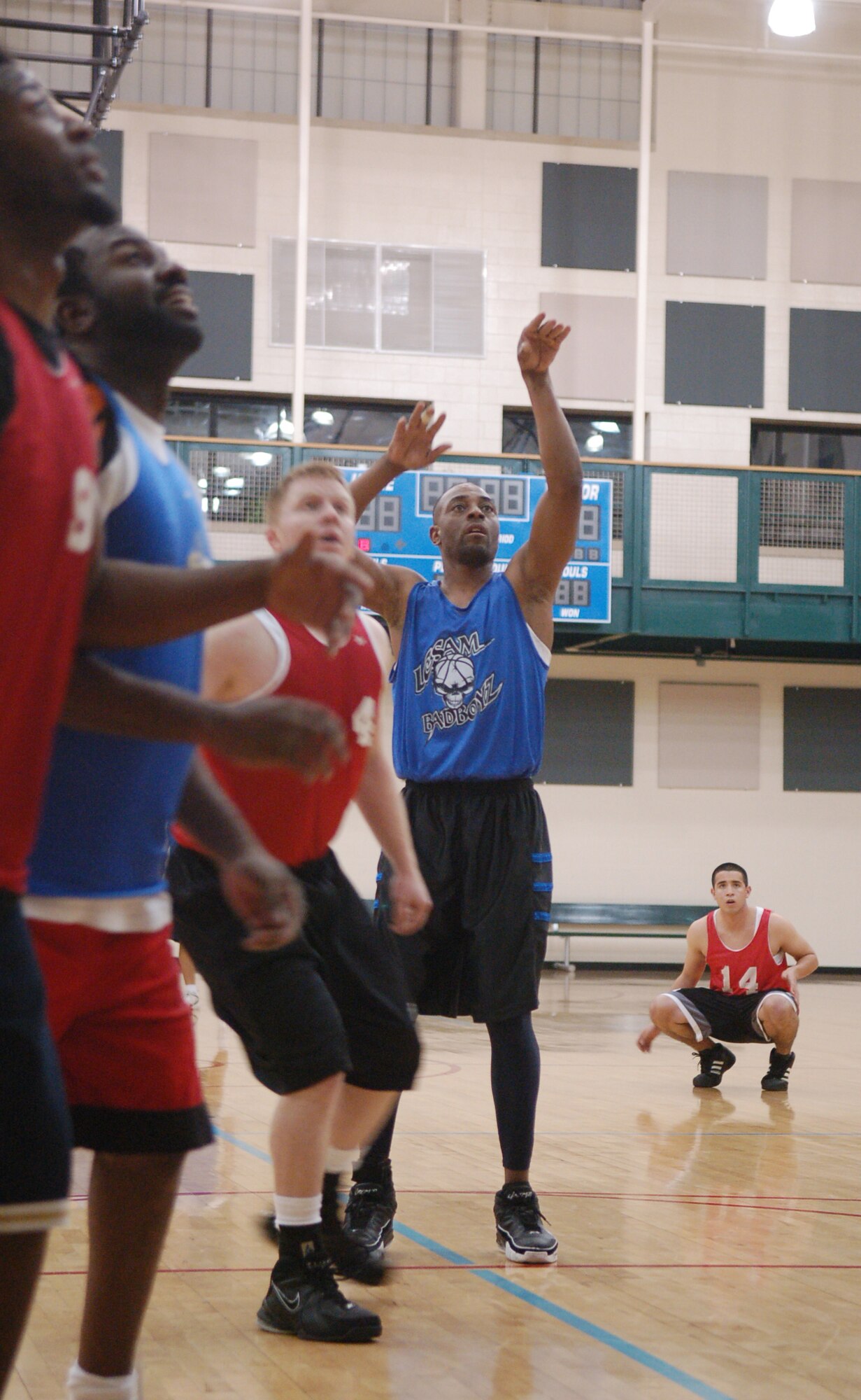 LAUGHLIN AIR FORCE BASE, Texas -- Members of the Laughlin Consolidated Services Aircraft Maintenance and 47th Operations Support Squadron intramural basketball teams anxiously watch and prepare to rebound a penalty free-throw shot put up by the LCSAM team's Ryan Dobbins Feb. 7.  The OSS team beat LCSAM 40-30.  (U.S. Air Force photo by Staff Sgt. Austin M. May)