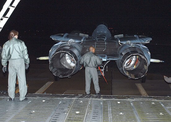 Master Sgt. Brenda Kremer stands by as Master Sgt. Bernard London performs a final check of a Navy F-14 Tomcat Feb. 6 before it is loaded into a C-5 Galaxy at Naval Air Station Oceana in Virginia Beach, Va.  The fighter is being transported to an aviation museum in Fort Worth, Texas.  The C-5 and aircrew are from the Air Force Reserve Command's 512th Airlift Wing at Dover Air Force Base, Del.  (U.S. Navy photo/Petty Officer Jason R. Zalasky)