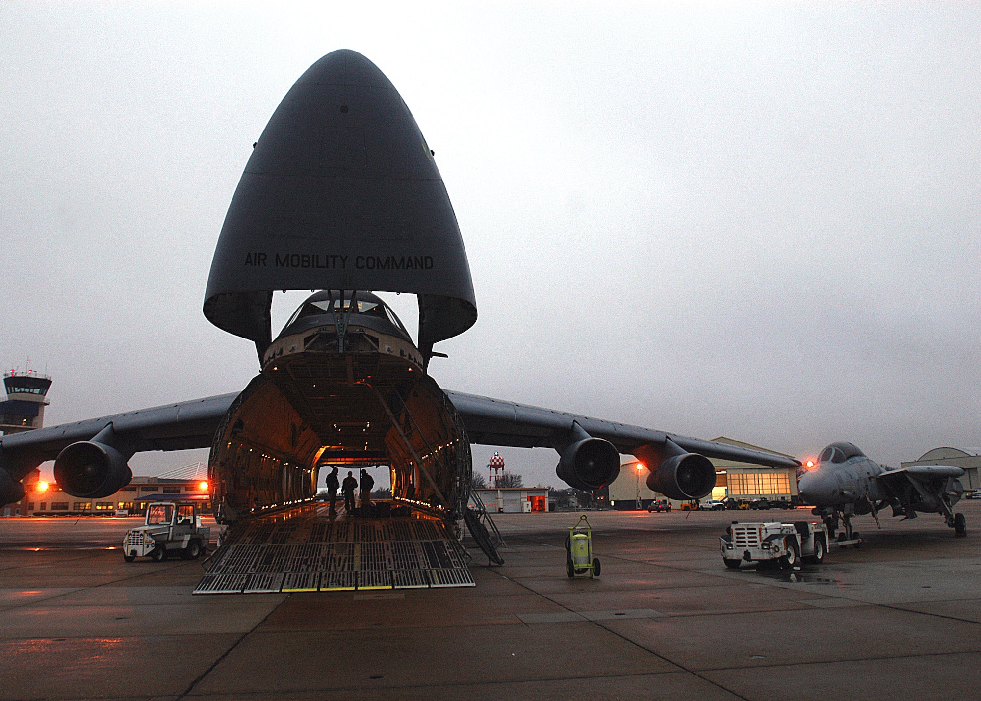 C-5 Galaxy loadmasters prepare to load a Navy F-14 Tomcat into the aircraft at Naval Air Station Oceana in Virginia Beach, Va., Feb. 5.  The fighter is being transported to an aviation museum in Fort Worth, Texas.  The C-5 and aircrew are from the Air Force Reserve Command's 512th Airlift Wing at Dover Air Force Base, Del.  (U.S. Navy photo/Petty Officer Jason R. Zalasky)