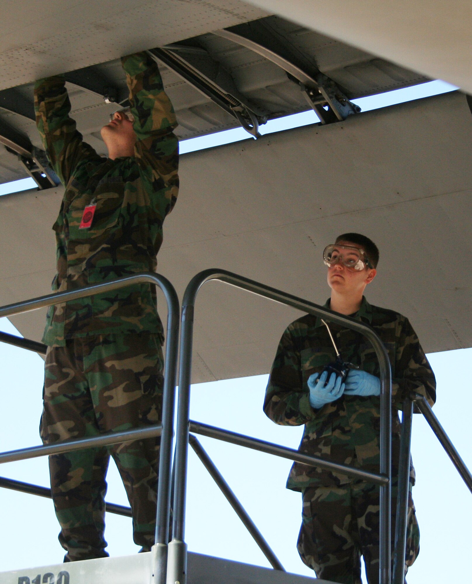 Airman Basic Matt Knef and Airman Basic Robert Mellonf rom the 362nd Training Squadron's C-130 Maitenance Coruse, lube the flaps and jack screws of a C-130 Hercules Feb. 7. (U.S. Air Force photo/Adrian McCandless)