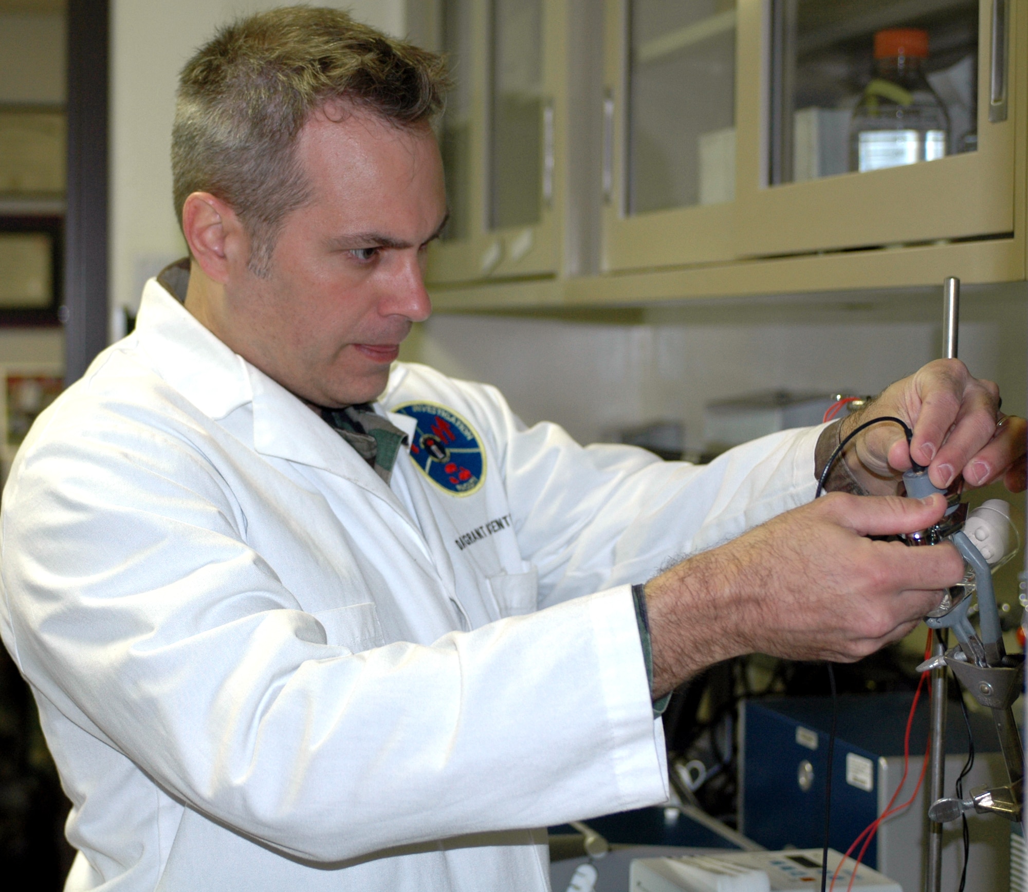 Maj. Eric Olsen, 60th Medical Support, works on creating DNA biosensors which can detect food-born pathogens such as salmonella. The process, known as real-time PCR, taxes approximately three hours to complete and is being performed in the field. Major Olsen is currently working on a process to create biosensors within 10 minutes. (U.S. Air Force photo by Jennifer Brugman)