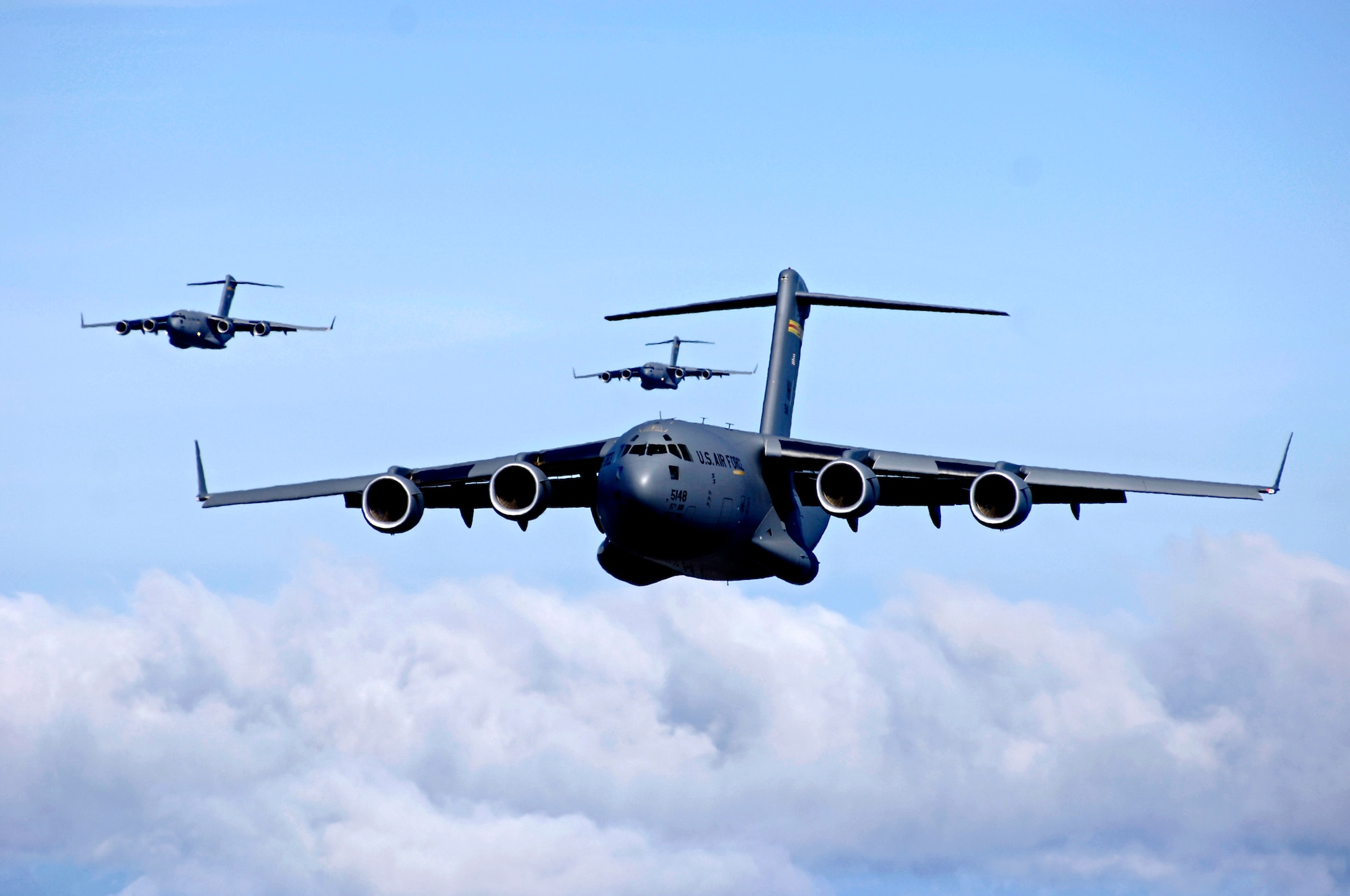 C-17 Globemaster IIIs fly in an airdrop training mission. Dover Air Force Base in Delware is preparing to receive the first of 13 C-17 Globemaster IIIs scheduled to arrive this summer. (U.S. Air Force photo/Tech. Sgt. Shane A. Cuomo) 