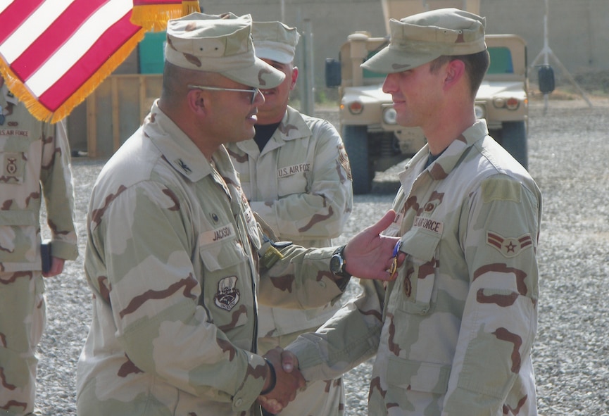 Then Airman 1st Class Jeremy Birchfield is presented the Purple Heart in a ceremony at Camp Victory, Iraq Sept. 24, 2006. The 824th Security Forces Squadron turret gunner was hit by a sniper during patrol operations Sept. 22, 2006. He is the first Airman from the 824th SFS to recieve the medal. (U.S. Air Force Photo by Staff Sgt. Jesse Smith)