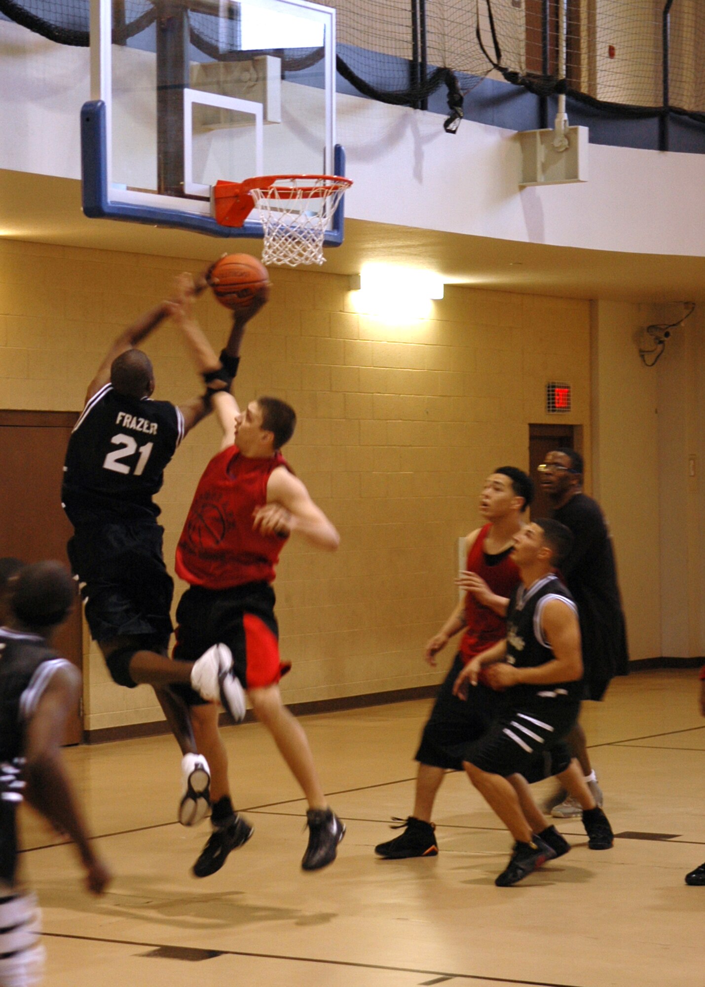 Holloman's Akenty Frazer drives past Cannon's defenders to drop in a layup during the first of two games at the 49th Services Fitness and Sports Center Feb. 3
