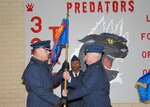 Col. Robert MacDonald, left, commander of the 737th Training Group at Lackland Air Force Base, Texas, receives the flag of the 321st Training Squadron from Lt. Col. Steve Cahanin during a Feb. 2 ceremony at the 321st TRS, which is temporarily standing down due to a current reduction in Air Force enlisted accessions. Colonel Cahanin, former 321st commander, now is commander of the 326th Training Squadron. (USAF photo by Robbin Cresswell)