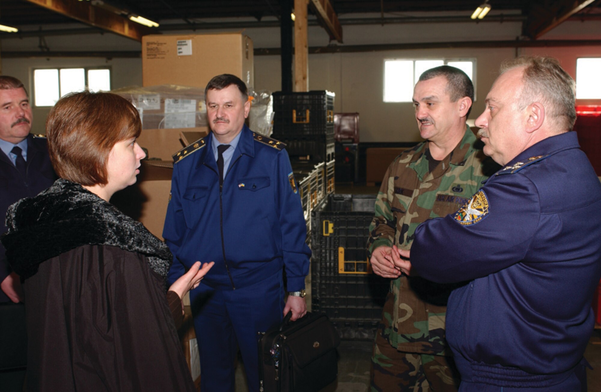 Chief Master Sgt. Dusty Kirk, 52nd Logistics Readiness Squadron, explains supply operations as, Iryna Yantalets, Ukrainian interpreter, translates for visiting Ukrainian armed forces officers. (US Air Force photo by Airman 1st Class Stephanie Sawyer)