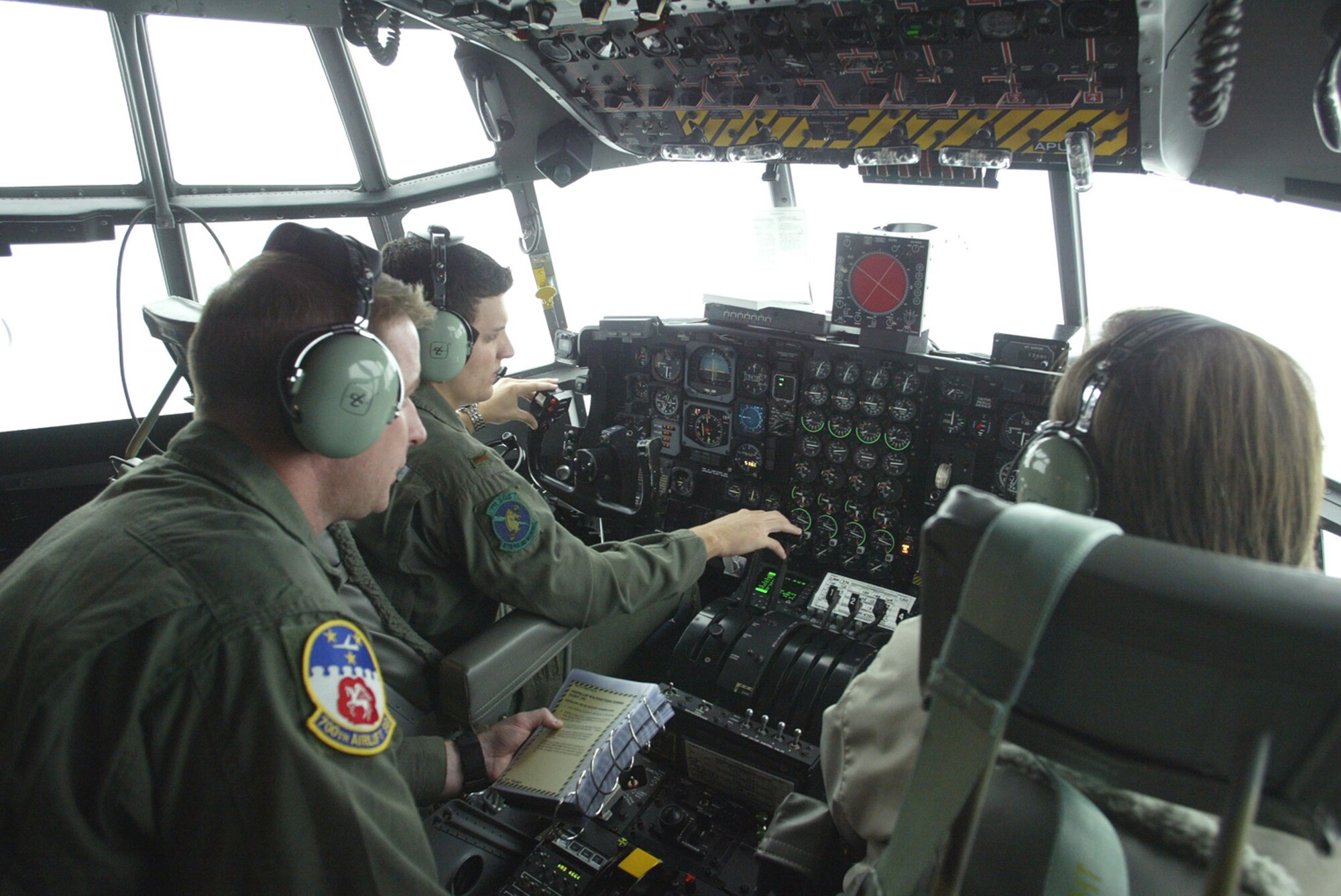 Instructor Engineer Mark Franke, in right seat, instructs 2nd Lt. John Karlesky, student pilot in the left seat and Staff Sgt. Kris Parson, a student engineer. The students are attending the Eastern Regional Flight Simulator here and the flight training device is a new tool to train C-130 crews. 
