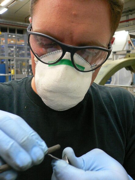 Staff Sgt. Robert Hanet, 52nd Component Maintenance Squadron, grinds the blades from the core of an F100 compressor engine. New blades are ground because they must match the exact length of damaged blades that are removed from the compressor. Sergeant Hanet is on temporary duty here from Selfridge Air National Guard Base, Mich. (US Air Force photo by Airman 1st Class Lawrence Herstel)
