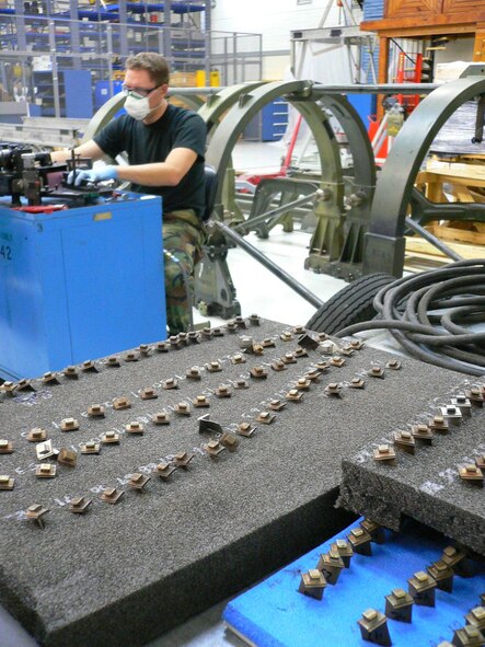Staff Sgt. Robert Hanet, 52nd Component Maintenance Squadron, grinds the blades from the core of an F100 compressor engine. New blades are ground because they must match the exact length of damaged blades that are removed from the compressor. Sergeant Hanet is on temporary duty here from Selfridge Air National Guard Base, Mich. (US Air Force photo by Airman 1st Class Lawrence Herstel)
