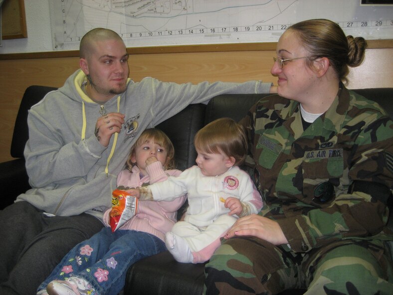 Staff Sgt. Elizabeth Aldridge, 52nd Equipment Maintenance Squadron, receives a visit at work from her husband Jon and their children Emma, 2, and Violet, 1. (US Air Force photo by Staff Sgt. Andrea Knudson)
