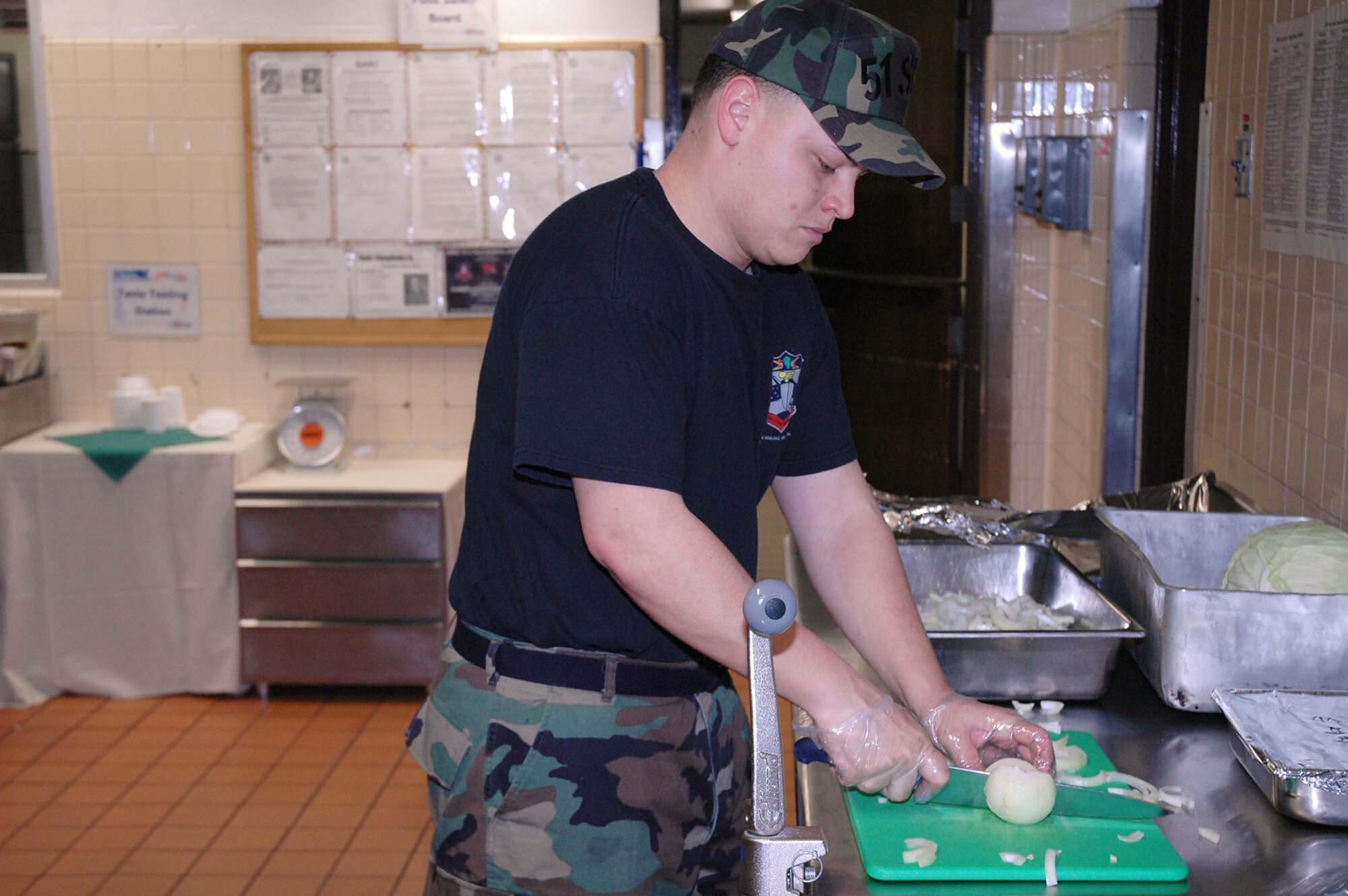 OSAN AIR BASE, Republic of Korea --  Senior Airman Jose Sierra, 51st Services Squadron, slices onions for a paprika beef dish Feb. 6. Senior Airman Sierra is a food service specialist at the Pacific House Dining Facility here. (U.S. Air Force photo by Staff Sgt. Benjamin Rojek)