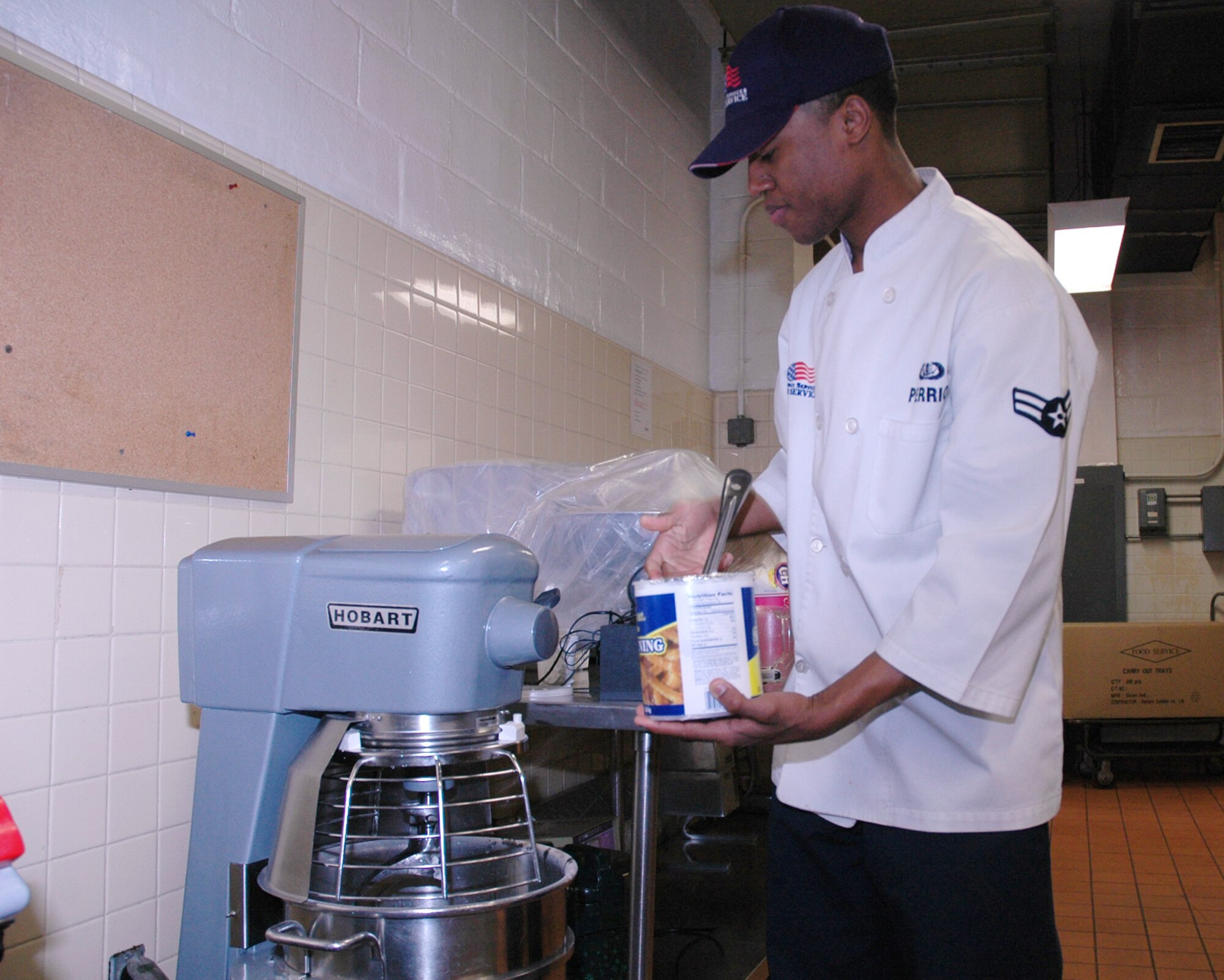 OSAN AIR BASE, Republic of Korea --  Airman 1st Class Randell Perrio, 51st Services Squadron, prepares dough for apple cobbler before dinner Feb. 6. Airman 1st Class Perrio is a food service specialist at the Pacific House Dining Hall here. (U.S. Air Force photo by Staff Sgt. Benjamin Rojek)