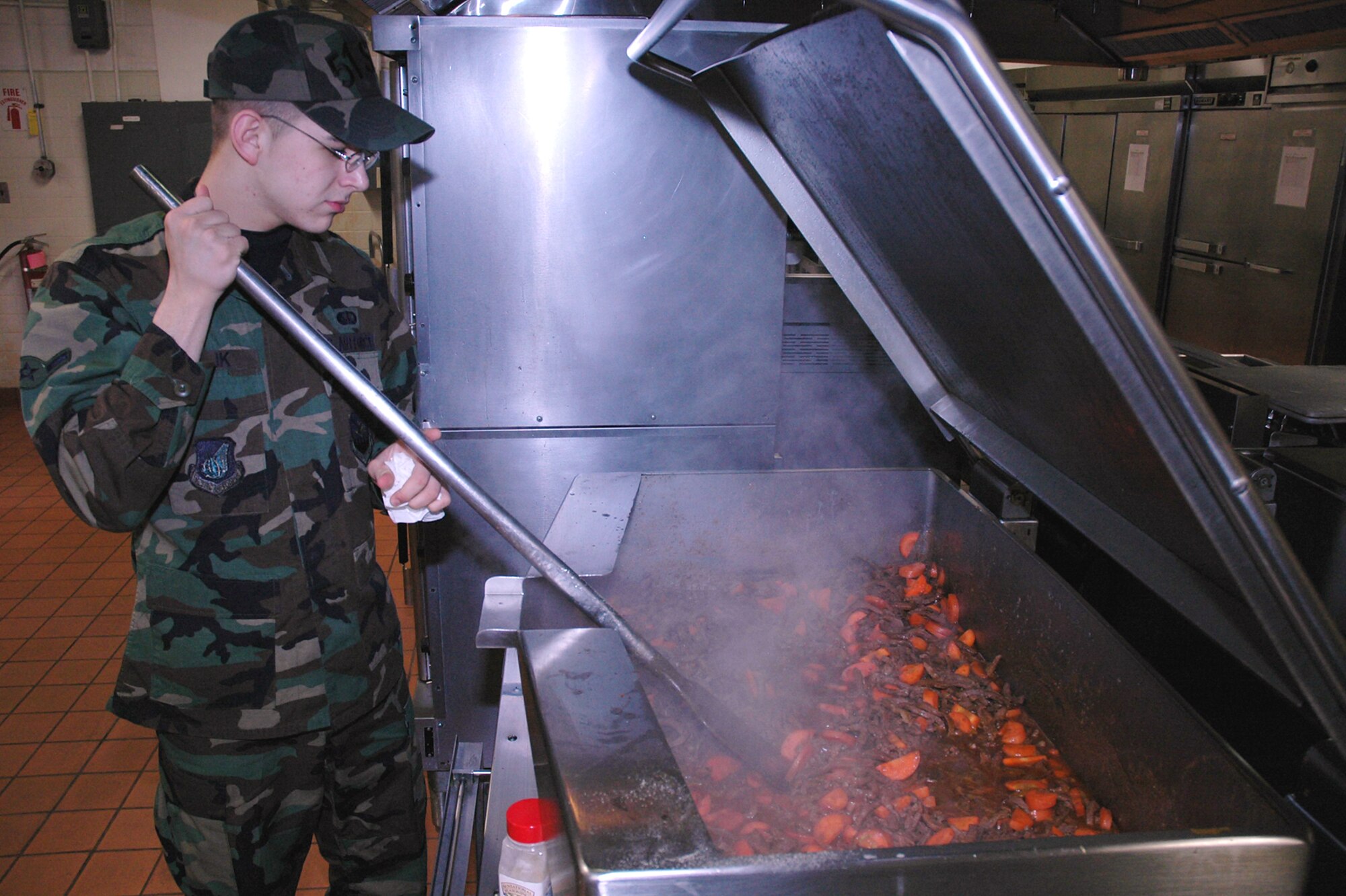 OSAN AIR BASE, Republic of Korea --  Airman Jason Relik, 51st Services Squadron, prepares paprika beef for dinner Tuesday. Airman Relik is a food service apprentice at the Pacific House Dining Facility here. (U.S. Air Force photo by Staff Sgt. Benjamin Rojek)