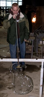 OSAN AIR BASE, Republic of Korea --  Senior Airman Joshua Stike, 5th Reconnaissance Squadron, learns how to blow glass on a recent ITT trip to a glass village where participants can learn how to make a glass vase for about $10. People can also purchase a variety of handcrafted glass pieces. The next trip is Feb. 24. (U.S. Air Force photo by Master Sgt. Ben Huseman)