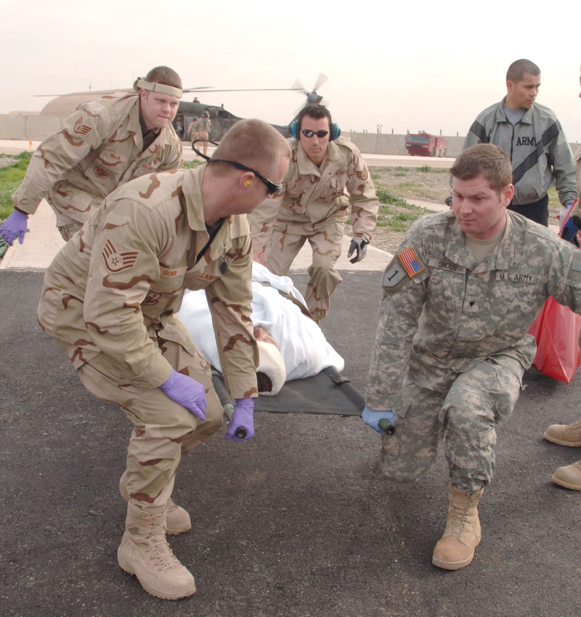 Airmen and Soldiers carry an Iraqi civilian injured during a Feb. 1 clash between the Iraqi Army and insurgents near Kirkuk. The patient was treated by the 506th Expeditionary Medical Squadron at Kirkuk Air Base before being transported to Balad Air Base. (U.S. Air Force photo/Senior Airman Bradley Lail) 