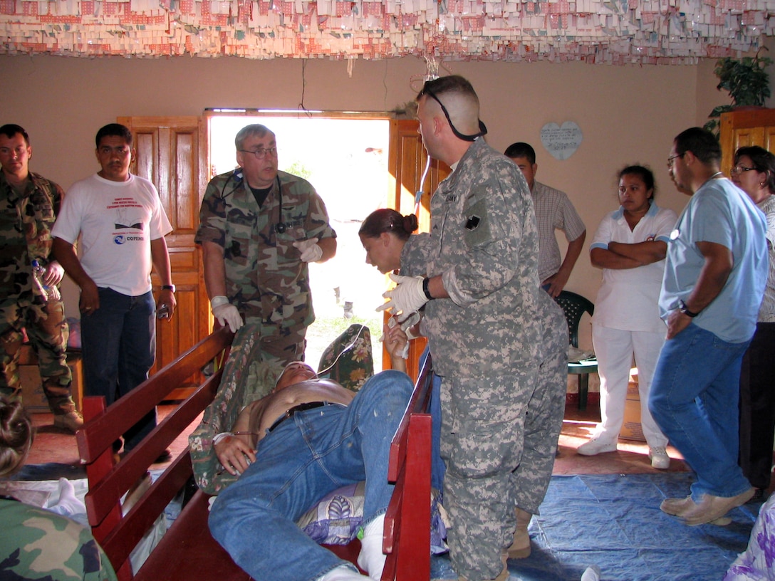 U.S. military personnel from Soto Cano Air Base begin treating a patient involved in a vehicle crash in a remote area of Honduras on Feb. 6. Three people died in the accident and 10 were injured. They were members of a nonprofit organization in Georgia and are in Honduras on a volunteer mission providing manual labor and teaching Bible school in Olancho, Honduras. Photo by Spc. John Destromp, USA