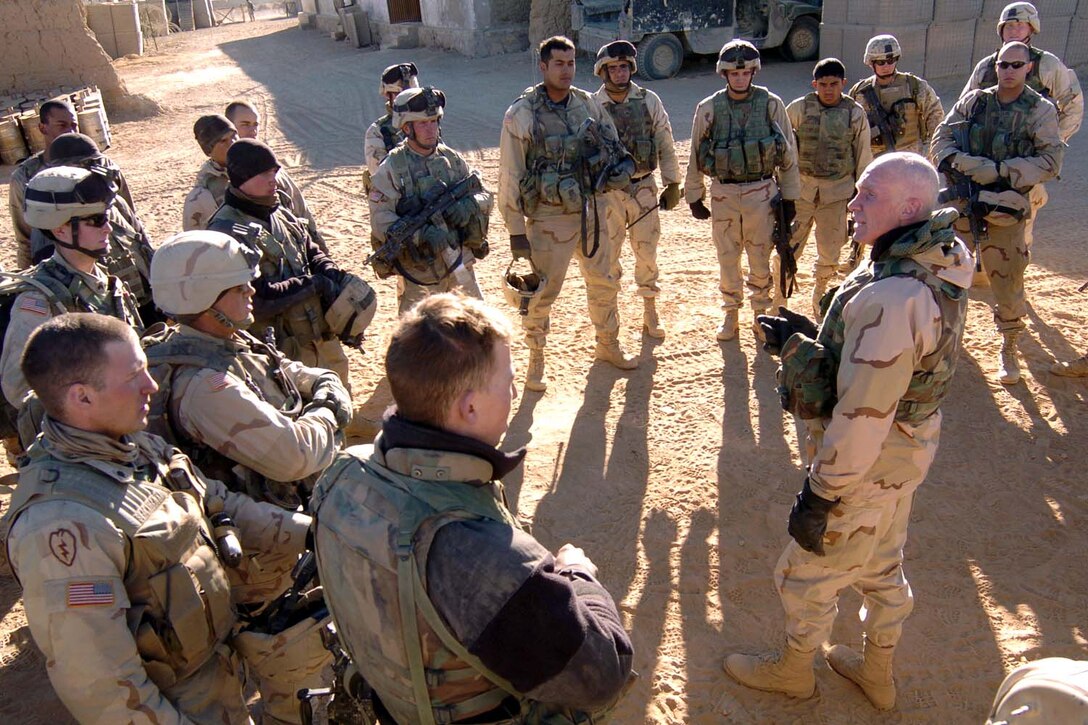 Army Maj. Gen. Eric T. Olson, commander of Combined Joint 
Task Force 76, talks to soldiers of Company C, 2nd Battalion, 27th Infantry 
Regiment on Christmas Day in Waza Khwa, Afghanistan, following a patrol through 
several nearby villages. Photo by Staff Sgt. Bradley Rhen, USA