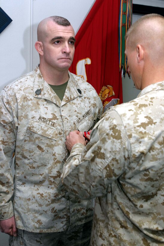 Lt. Col. Julian D. Alford, 3rd Battalion, 6th Marine Regiment 
battalion commander, pins the Bronze Star medal with combat "V" device on 
Gunnery Sgt. William E. Bodette, company gunnery sergeant, Company K, 3rd 
Battalion, 6th Marine Regiment.  Bodette received his award for his bold 
tactical decisions during three separate ambushes in Afghanistan. Marine Corps 
photo