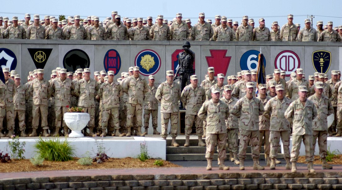 The 76th Infantry Brigade, Indiana National Guard, is honored 
at a departure ceremony at the Veterans' Memorial at Camp Atterbury, Ind., in 
August. The brigade is currently supporting the training of the Afghan National 
Army at Camp Phoenix near Kabul, Afghanistan. The crests at the memorial 
represent the major commands that have trained and deployed from Camp Atterbury 
since the Joint Maneuver Training Center was founded in 1942. Photo by Sgt. Les 
Newport, USA