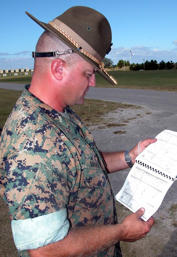 Marine Chief Warrant Officer Timothy Soignet looks at target  strikes displayed in a data book Nov. 2 at Chosin Range at Marine Corps Recruit  Depot Parris Island, S.C. Photo by Gerry J. Gilmore