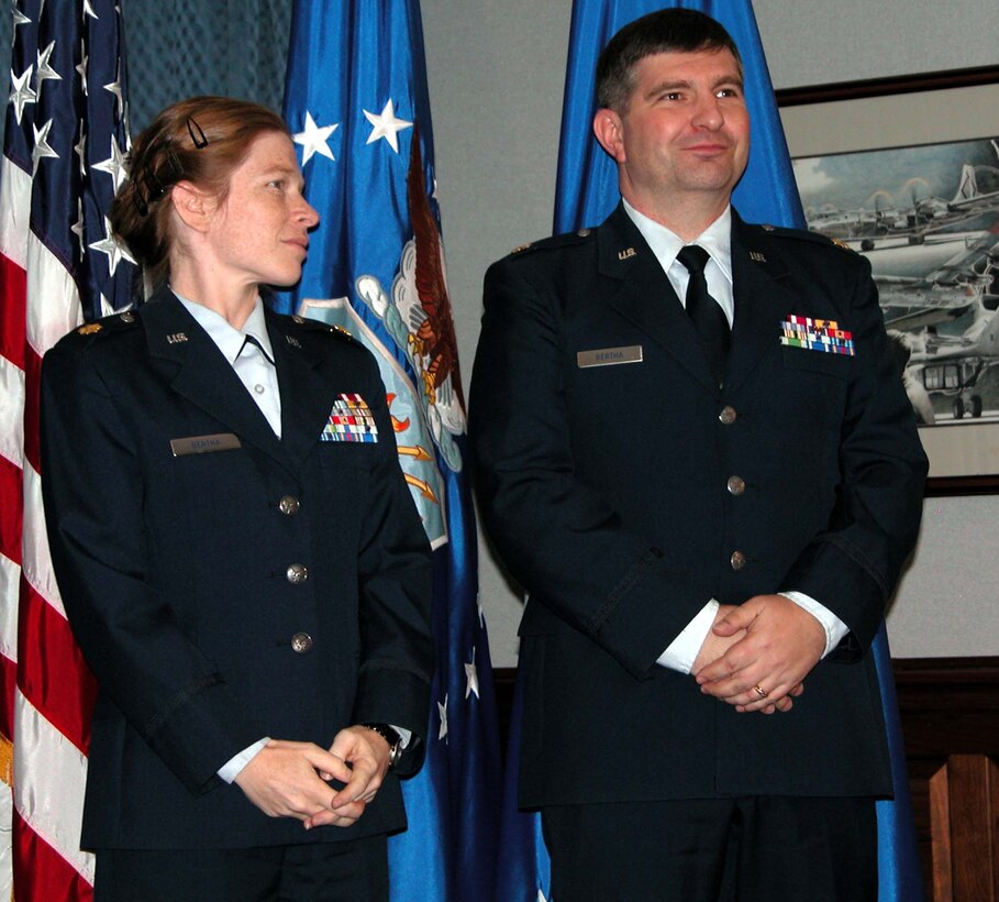 Air Force Maj. Valerie Bertha prepares to present her husband,  Air Force Maj. John Bertha, with the Spouse Pin. John said the experience of  raising children without a spouse can be "very tough." Photo by Sgt. 1st Class  Doug Sample, USA
