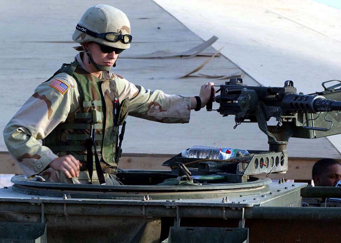 When she isn't pulling duty on a .50-caliber machine gun, 
Army Reserve Sgt. Lisa Phillips is a tractor-trailer driver in the 630th 
Transportation Company, now on duty in Iraq. Photo by Master Sgt. Jack Gordon, 
USA