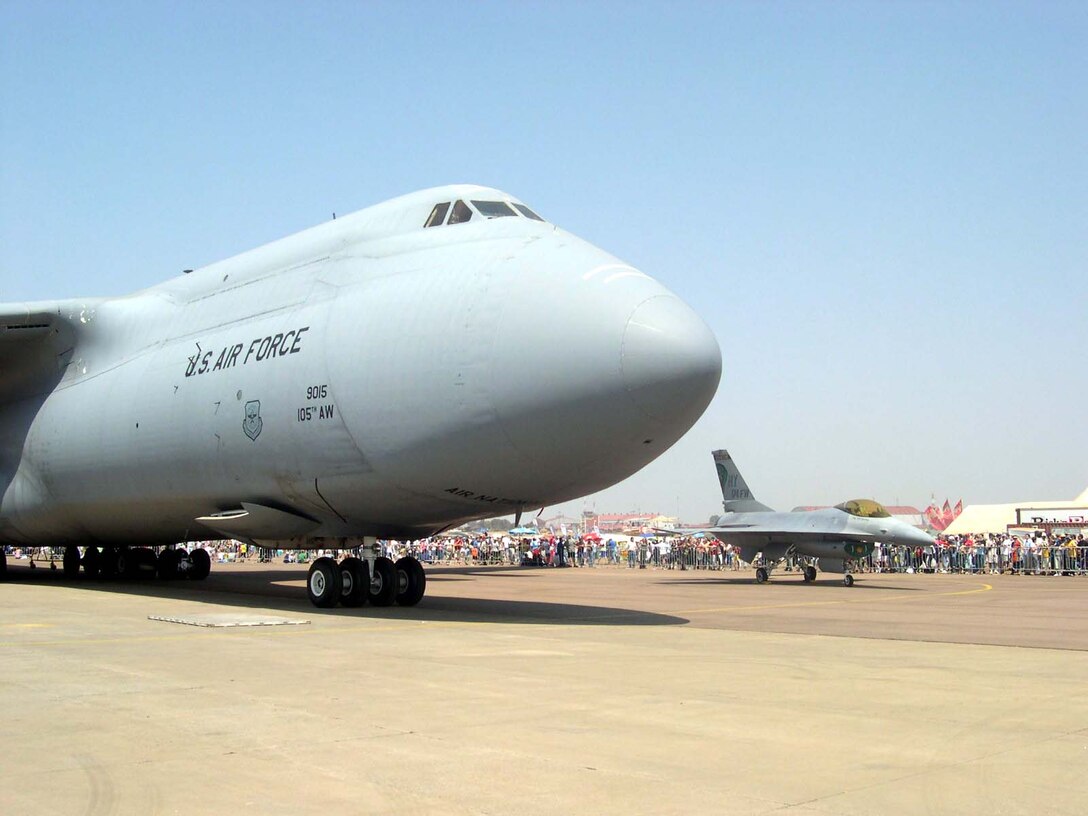 A C-5 Galaxy transport from Stewart Air National Guard Base in  New York and an F-16C Fighting Falcon from the 174th Fighter Wing, New York Air  National Guard, sit on display at the South Africa Aerospace Exhibition at  Waterkloof Air Force Base, Pretoria, South Africa. The event marks the first  time airframes and guardsmen from New York have participated in a South African  air show. Photo by Staff Sgt. Matthew Johnson, USAF