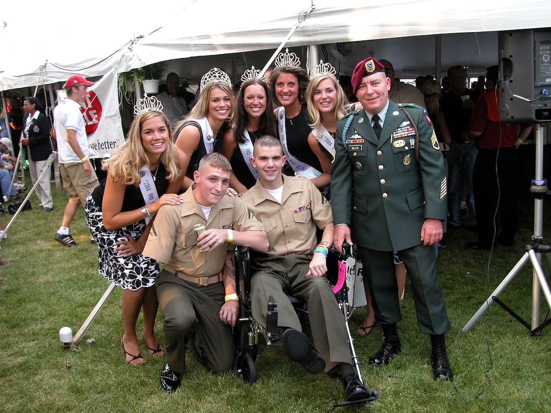 Marine Lance Cpls. Christopher Johnson of Lancaster, Pa., and 
Kevin Rumley of Fairfax, Va., and Army Staff Sgt. Thomas Gillis of 
Massachusetts get some individual attention from the 2004 Hall of Fame queen 
and her court Aug. 9 before the National Football League's Hall of Fame game. 
The three received Purple Hearts for injuries they suffered in Afghanistan and 
Iraq. Photo by Samantha L. Quigley