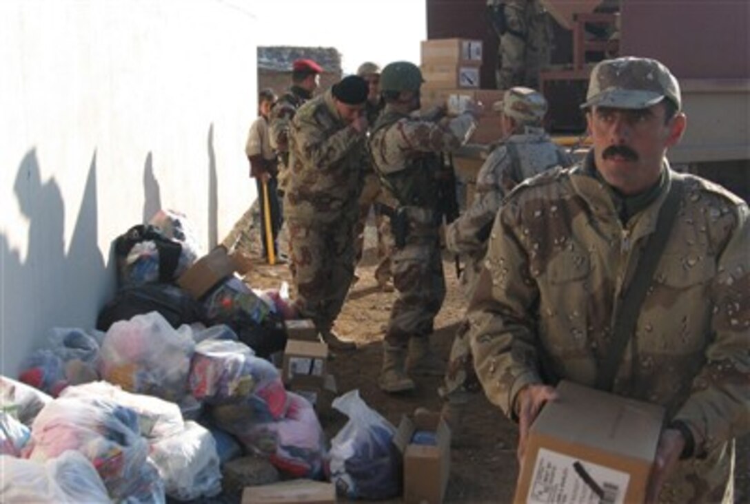 Iraqi army soldiers of the 3rd Brigade, 2nd Iraqi Army Division, and the 45th Sustainment Brigade unload boxes of toys and water for distribution to locals during a medical assessment being conducted by the soldiers in Shafa'at, Iraq, Feb. 1, 2007. 