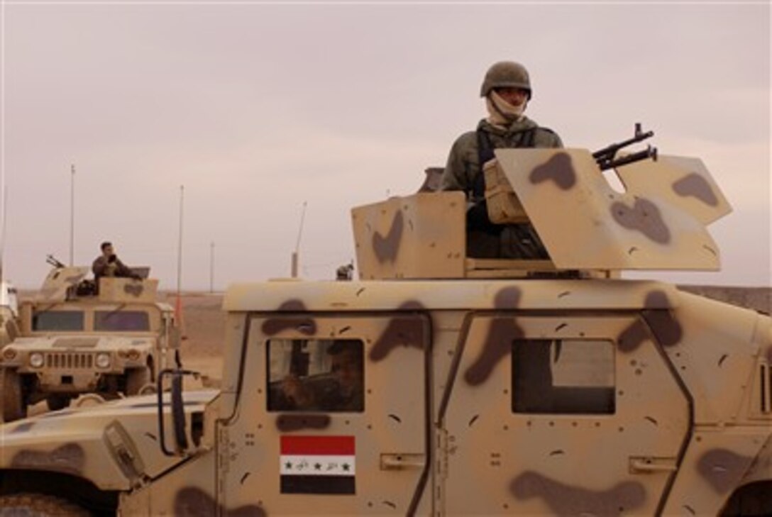 Iraqi army soldiers assigned to 1st Battalion, 2nd Brigade, 4th Infantry Division drive into Zanjaliah, Iraq, Feb. 1, 2007, during an operation to find weapons caches, personnel of high interest and gather intelligence.