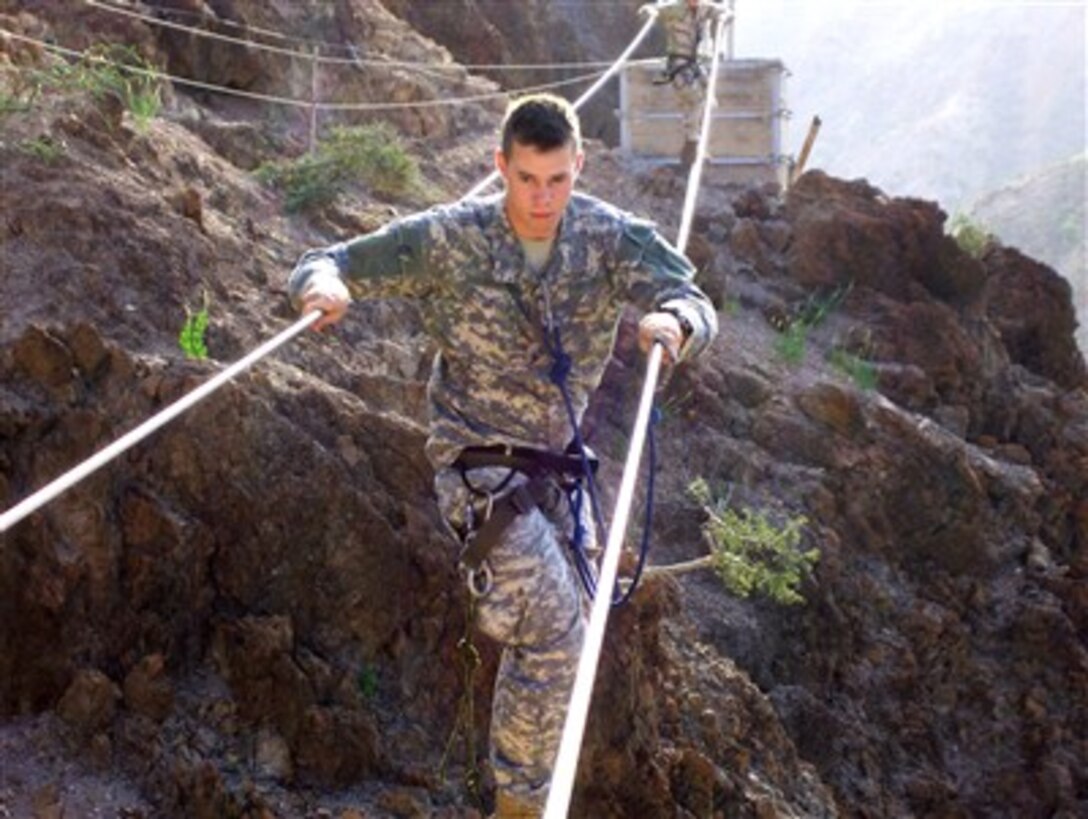 U.S. Army Spc. Anthony Slocomb crosses a three-rope bridge as he completes the French Foreign Legion commando course in Arta, Djibouti, on Jan. 28, 2007.  Slocomb is attached to Alpha Company, 1st Battalion, 16th Infantry Regiment, Combined Joint Task Force - Horn of Africa.  The commando course is a five-day training evolution, which culminates with a confidence course.  