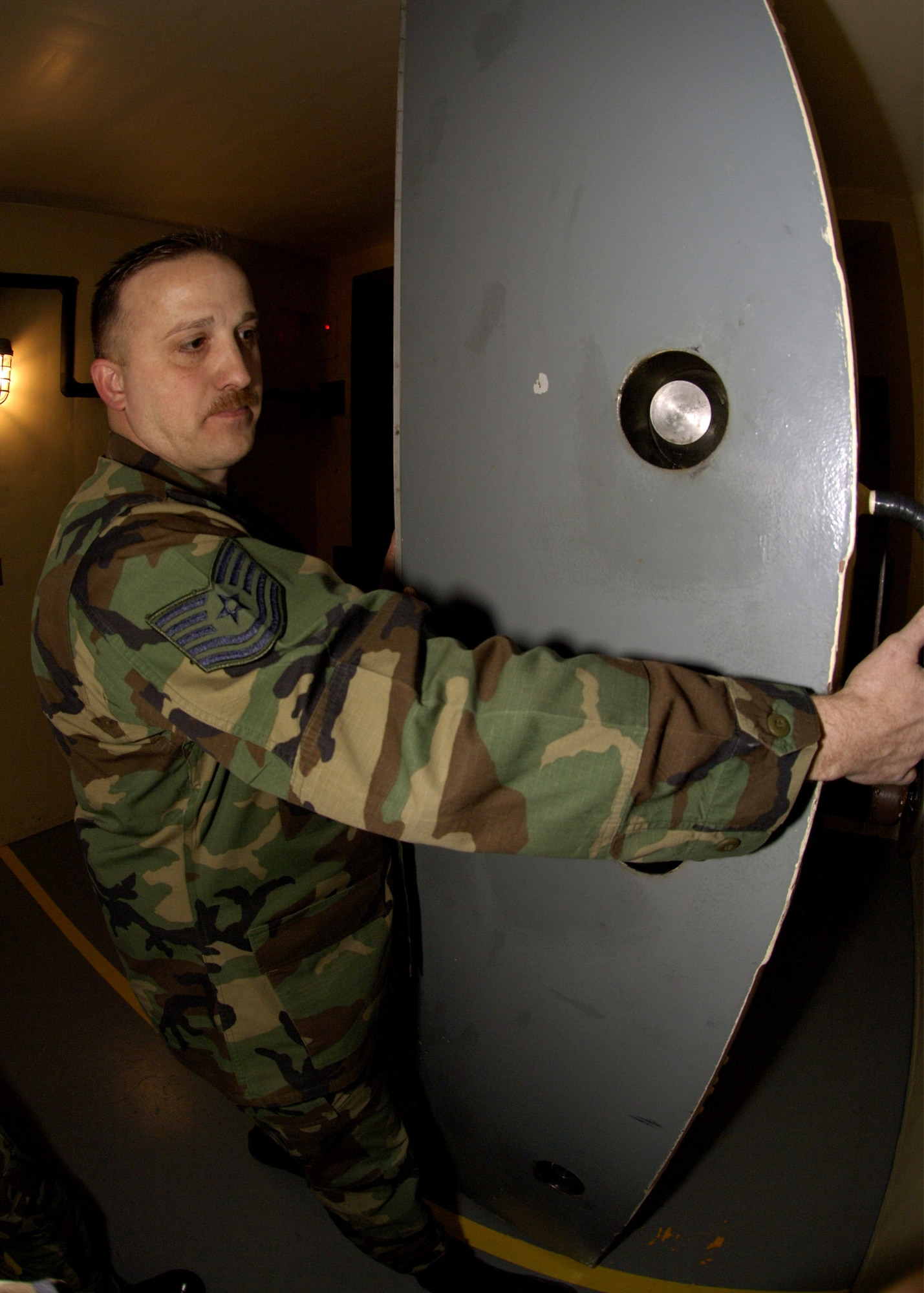 Tech. Sgt. Paul Bobenmoyer, a facility manager at Alpha-1 Missile Alert Facility, opens the blast door of the underground passageway that leads to the launch control center and the launch control equipment building Feb. 7.  Sergeant Bobenmoyer is assigned to the 319th Missile Squadron at F.E. Warren Air Force Base, Wyo.  (U.S. Air Force photo/Senior Airman Javier Cruz Jr.)