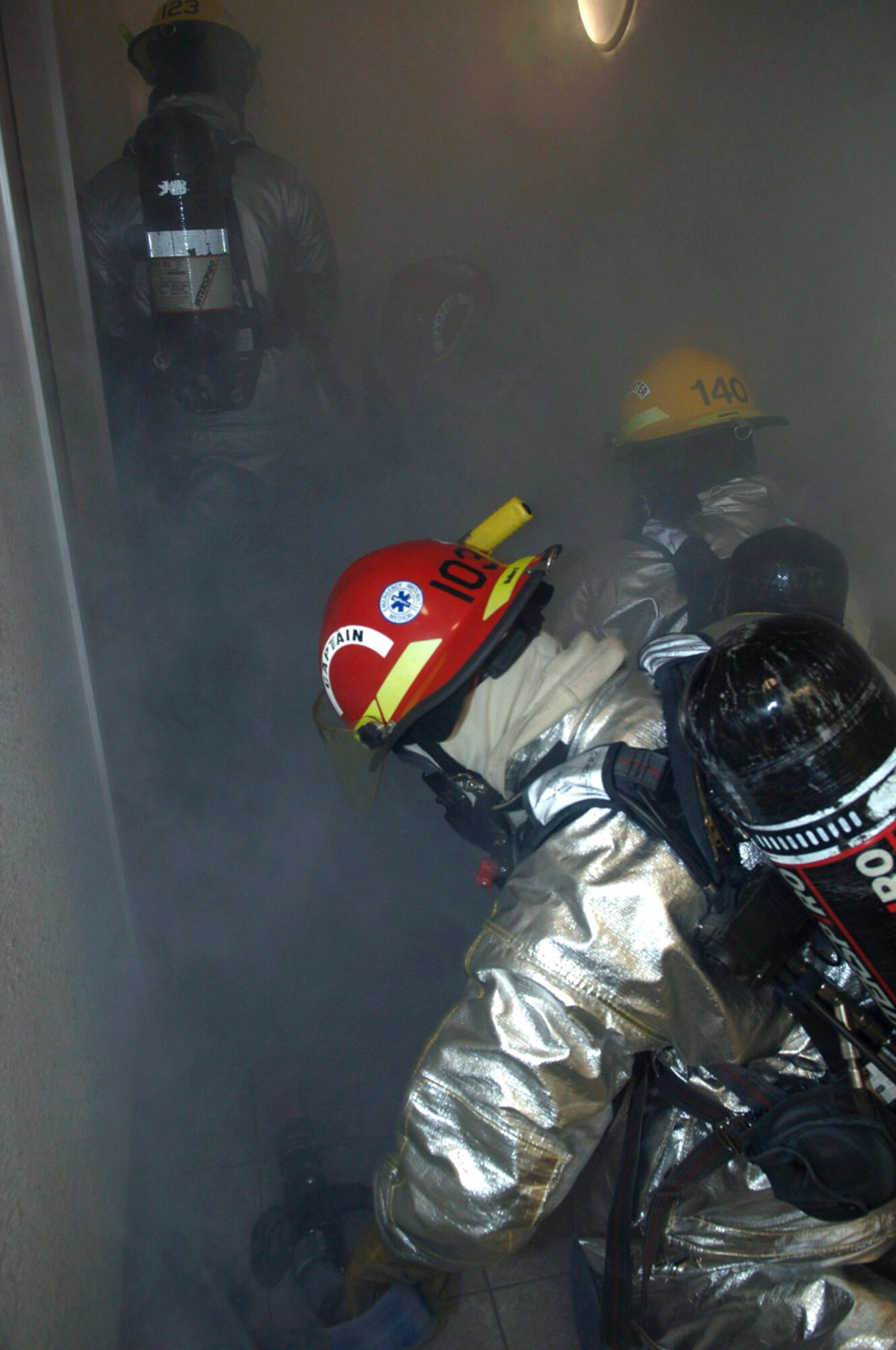 Senior Airman Michael Lewis, Airman 1st Class Robert Whitaker and Tech. Sgt. Steven Nordlund extract personnel from a building during a simulated fire and evacuation at Davis-Monthan Air Force Base, Ariz., in preparation for an operational readiness inspection. The three Airmen are firefighters assigned to the 355th Civil Engineer Squadron. (U.S. Air Force photo/Senior Airman Christina D. Ponte)
