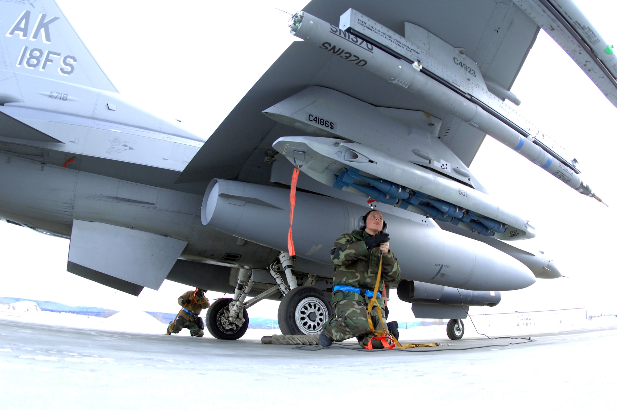 Senior Airman Amanda Debkowski (front) and Senior Airman Joshua McCathern prep an F-16 Fighting Falcon Feb. 8 at Eielson Air Force Base, Alaska. The 354th Maintenance Squadron Airmen are responsible for arming all weapons and making sure aircraft are ready for flight. The 18th Fighter Squadron conducts air operations for combat-ready F-16 aircraft and provides close-air support, forward air control, battlefield air interdiction, and offensive counter air. (U.S. Air Force photo/Staff Sgt. Joshua Strang)
