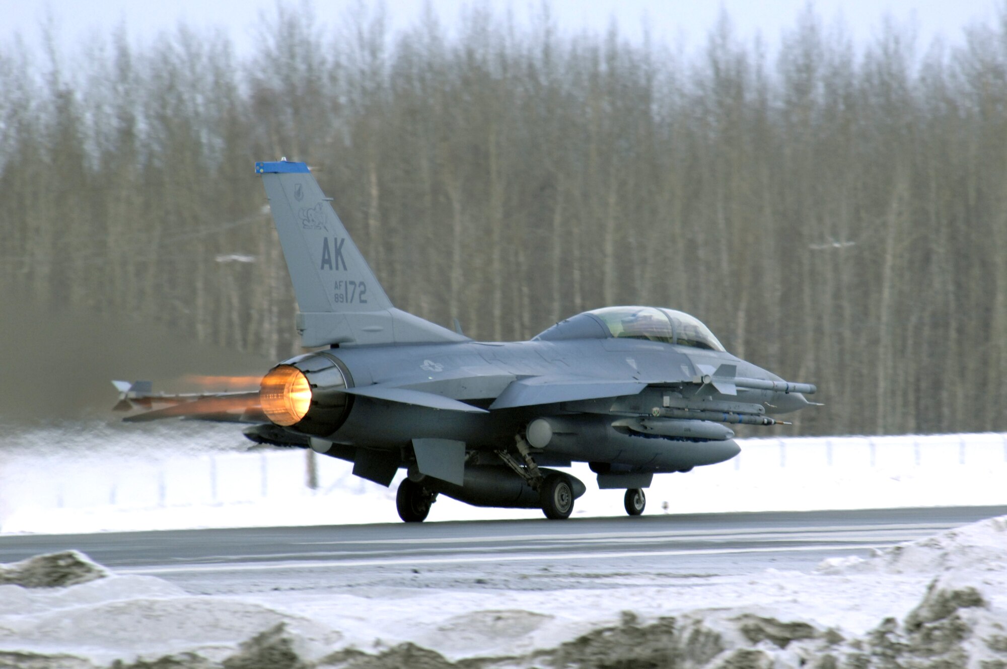 An F-16 Fighting Falcon takes off Feb. 8 at Eielson Air Force Base, Alaska. The 18th Fighter Squadron conducts air operations for combat-ready F-16 aircraft and provides close air support, forward air control, battlefield air interdiction, and offensive counter air. (U.S. Air Force photo/Staff Sgt Joshua Strang) 
