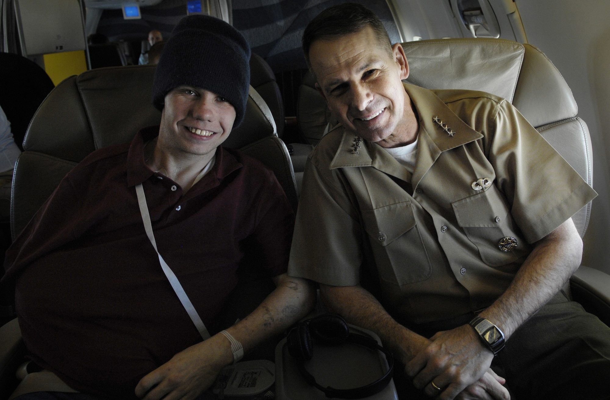 Marine Lance Cpl. Steven Eastburn and Chairman of the Joint Chiefs of Staff, Gen. Peter Pace, pose for a picture while flying to Hawaii, Feb. 8. While refueling at Travis, General Pace offered a ride to the injured Marine that was waiting for transportation to his home unit in Hawaii. (DoD photo by Staff Sgt. D. Myles Cullen)(released)