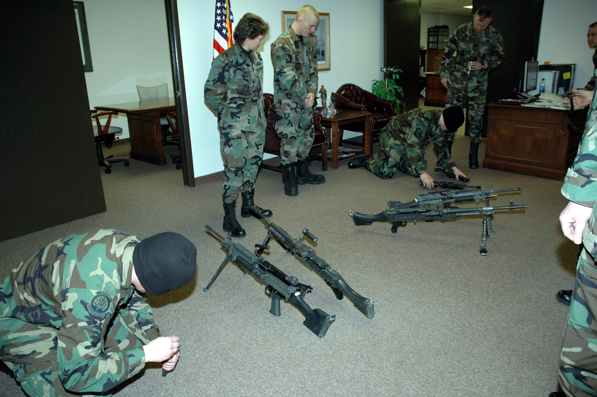 Col. Sandy Finan, 341st Space Wing commander, along with Senior Airman Jason Daniels and Maj. Raymond Tembreull, 741st Missile Security Forces commander, watch Tactical Response Force members Senior Airman Zachary Hawn (left) and Airman 1st Class Ryan Link assemble various weapons while blindfolded.