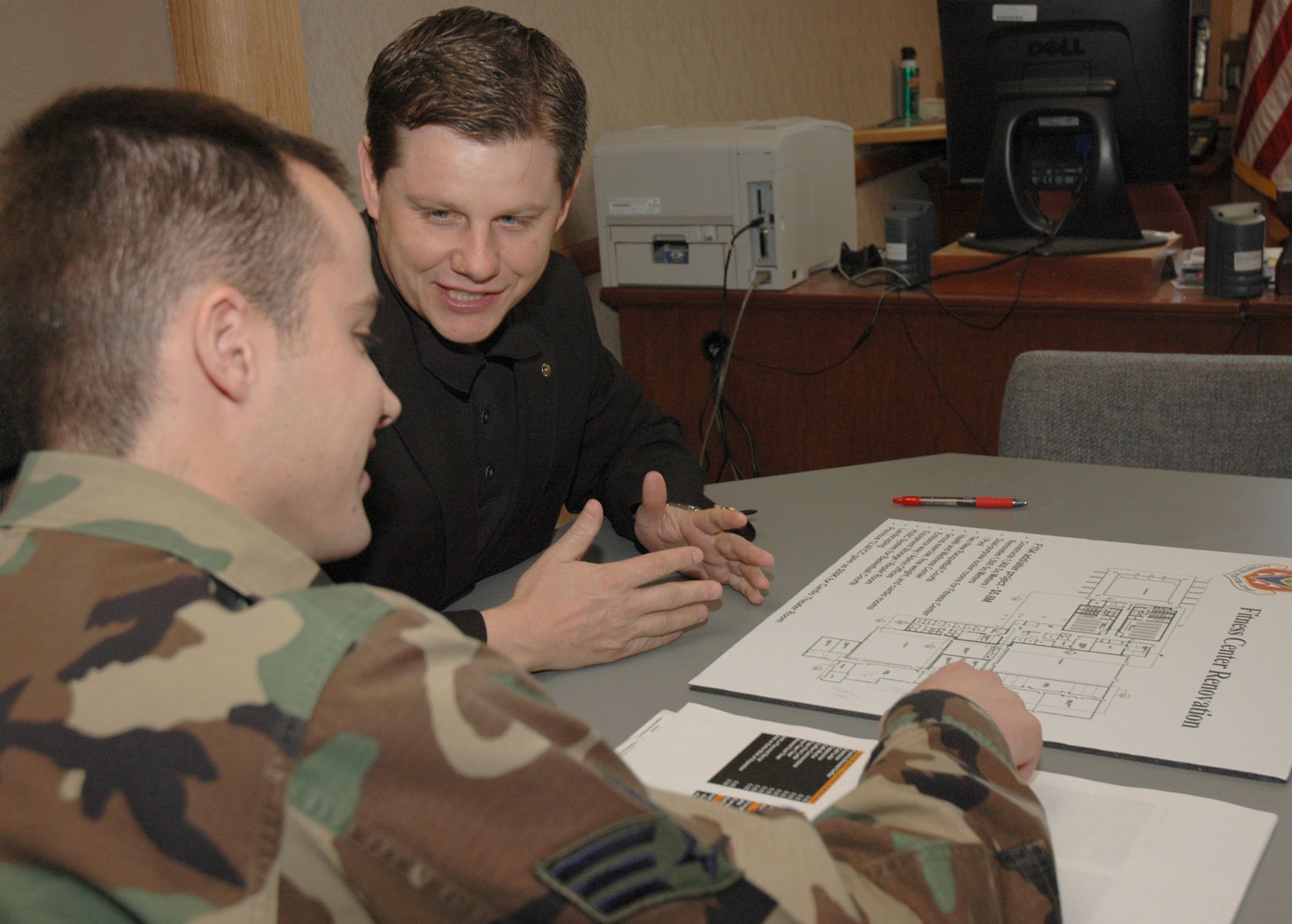 MOUNTAIN HOME AIR FORCE BASE, Idaho -- Blaine Miller meets with Senior Airman Daniel Brennan to discuss physical fitness initiatives for the fitness center here. Squadron officials credited Mr. Miller for helping the squadron win Air Combat Command’s Eubanks and Hennessey trophies. He also started a series of base town hall forums which led to 23 new initiatives based on customer requests mentioned during these meetings. Air Force photo by Airman Samantha S. DeVries