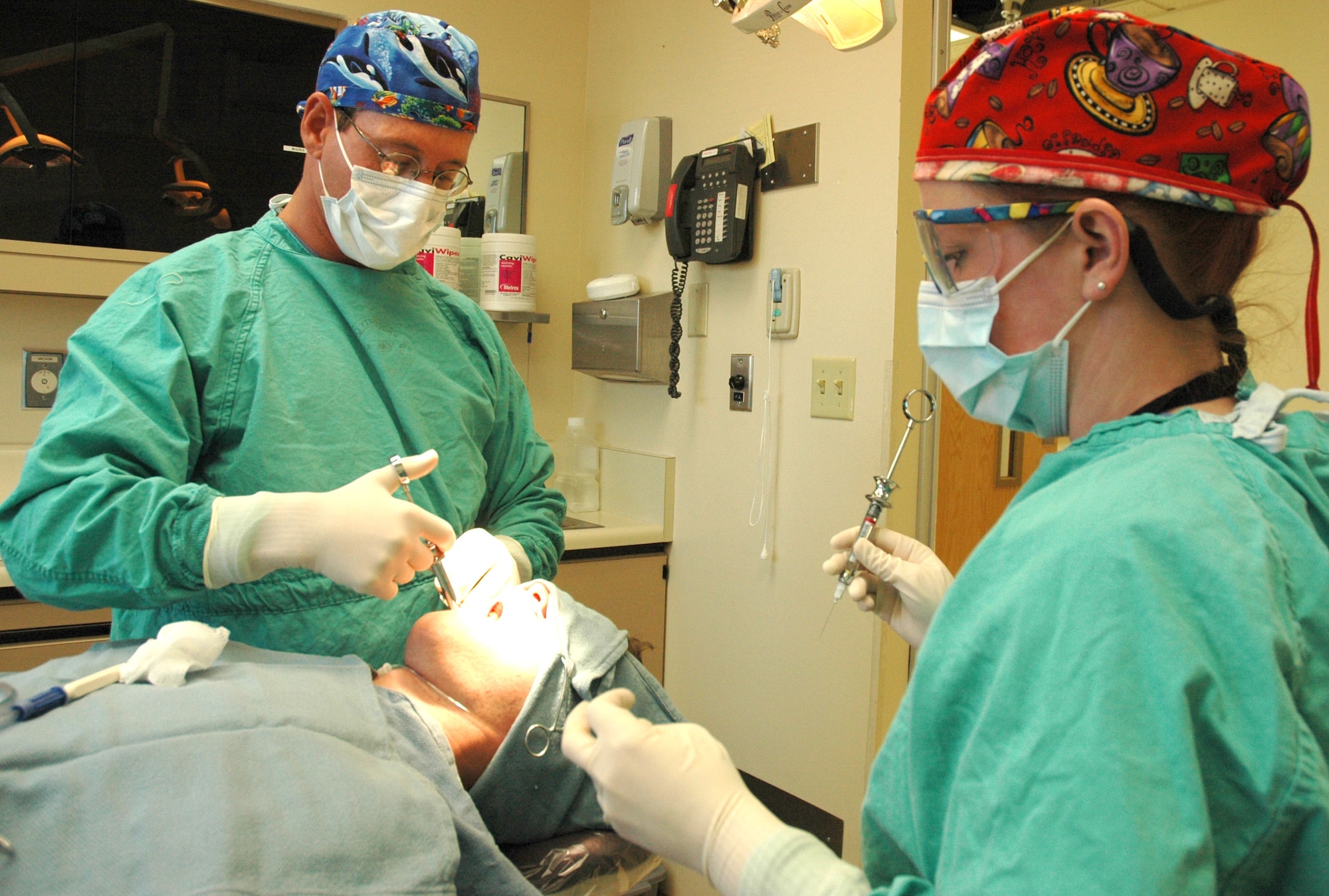 MOUNTAIN HOME AIR FORCE BASE, Idaho -- Lt. Col. (Dr.) Dennis M. Van Maren and dental assistant Sandra Stewart prepare to extract the wisdom teeth of Airman 1st Class Joseph Phipps from the 366th Aircraft Maintenance Squadron. The colonel provided $3.3 million in dental care to patients stationed here over the past year which exceeded the Air Force’s goal by 150 percent and helped the medical group earn the 2005 Air Force Top Performing CONUS Military Treatment Facility title. Air Force photo by Master Sgt. Brian S. Orban