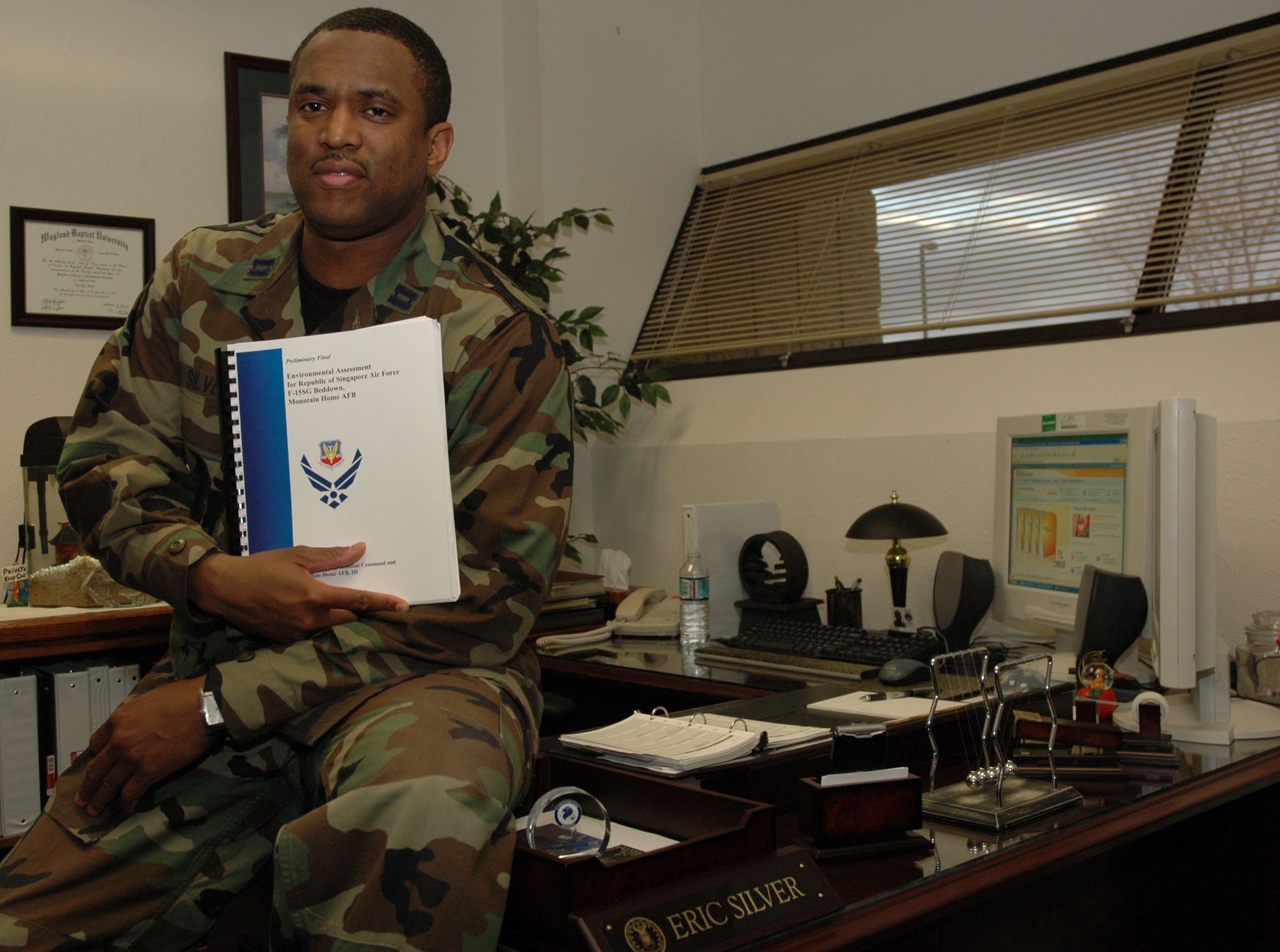 MOUNTAIN HOME AIR FORCE BASE, Idaho -- Capt. Eric Silver poses with the Republic of Singapore air force reception plan -- one of many plans the captain oversees as the chief of receptions and deployments with the 366th Fighter Wing plans and programs office. In 2006, the captain coordinated 32 international and U.S. temporary duty assignments and site surveys over a four-month period, which included a recent Pakistani air force visit here. Air Force photo by Master Sgt. Brian S. Orban