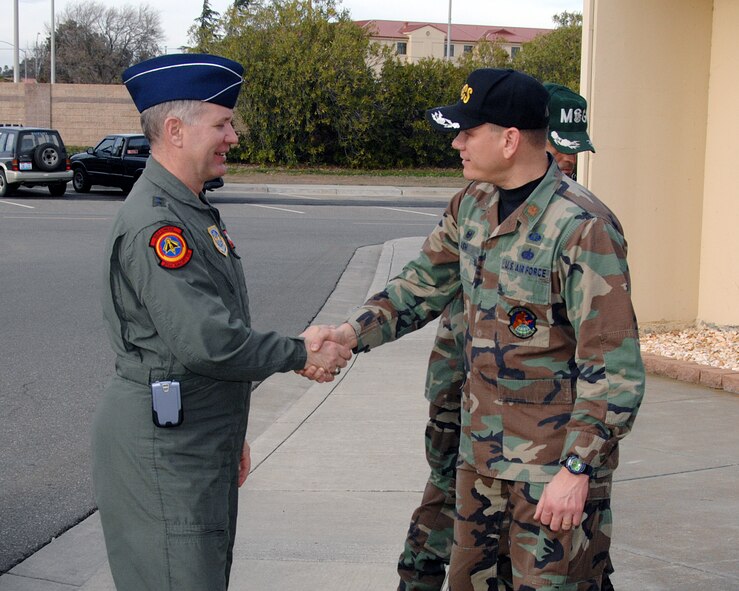 Maj. Reginald Ash, 60th Communications Squadron commander, greets Maj. Gen. Ronald Ladnier, commander of the 18th Air Force Tanker Airlift Control Center, Scott Air Force Base, Ill. General Ladnier visited the 60th CS to check on the status of the Alternate Tanker Airlift Control Center. (U.S. Air Force photo by David Cushman)
