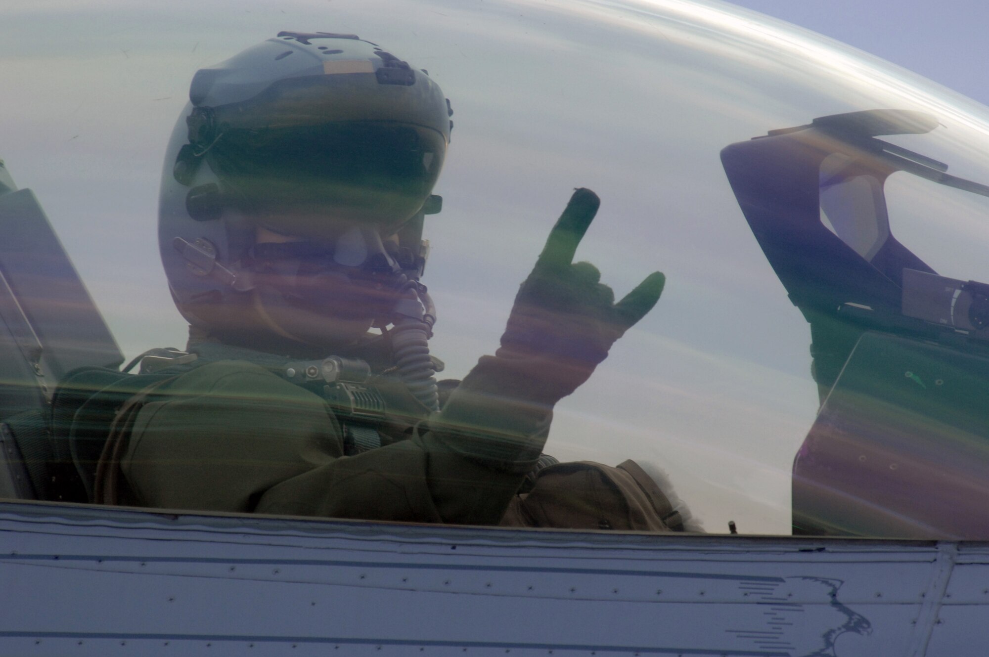 EIELSON AIR FORCE BASE, Alaska -- An F-16 Fighting Falcon pilot from the 18th Fighter Squadron signals from his aircraft prior to taking off for a training mission here on Feb.8. The 18th Fighter Squadron conducts air operations for combat-ready F-16 aircraft and provides close air support, forward air control (airborne), battlefield air interdiction, and offensive counter air.
(U.S. Air Force Photo by Staff Sgt Joshua Strang)