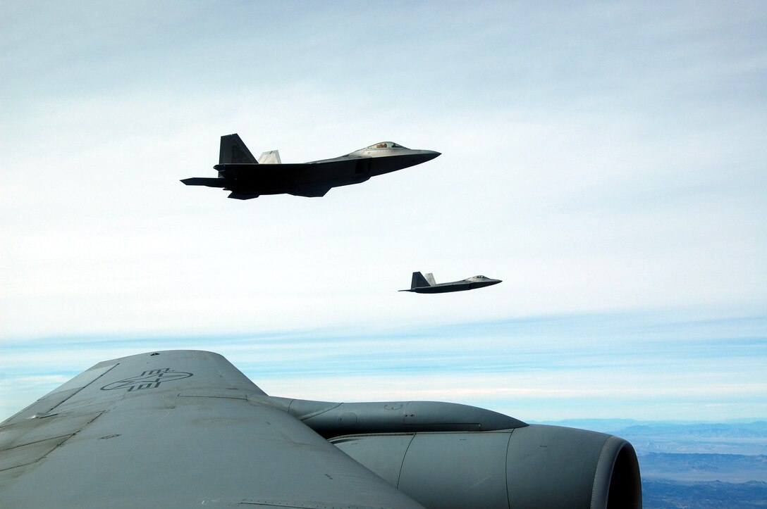An F-22 Raptor flys off the left wing of a KC-135 Stratotanker during the Red Flag Exercise Feb 7. Two KC-135 Stratotankers from the 319th Air Refueling Wing at Grand Forks Air Force Base make up the lead tanker unit during the exercise. Red Flag is an exercise designed to hone the warfighting skills of Air Force pilots for conflicts. (U.S. Air Force photo/1st Lt. Randi Norton)