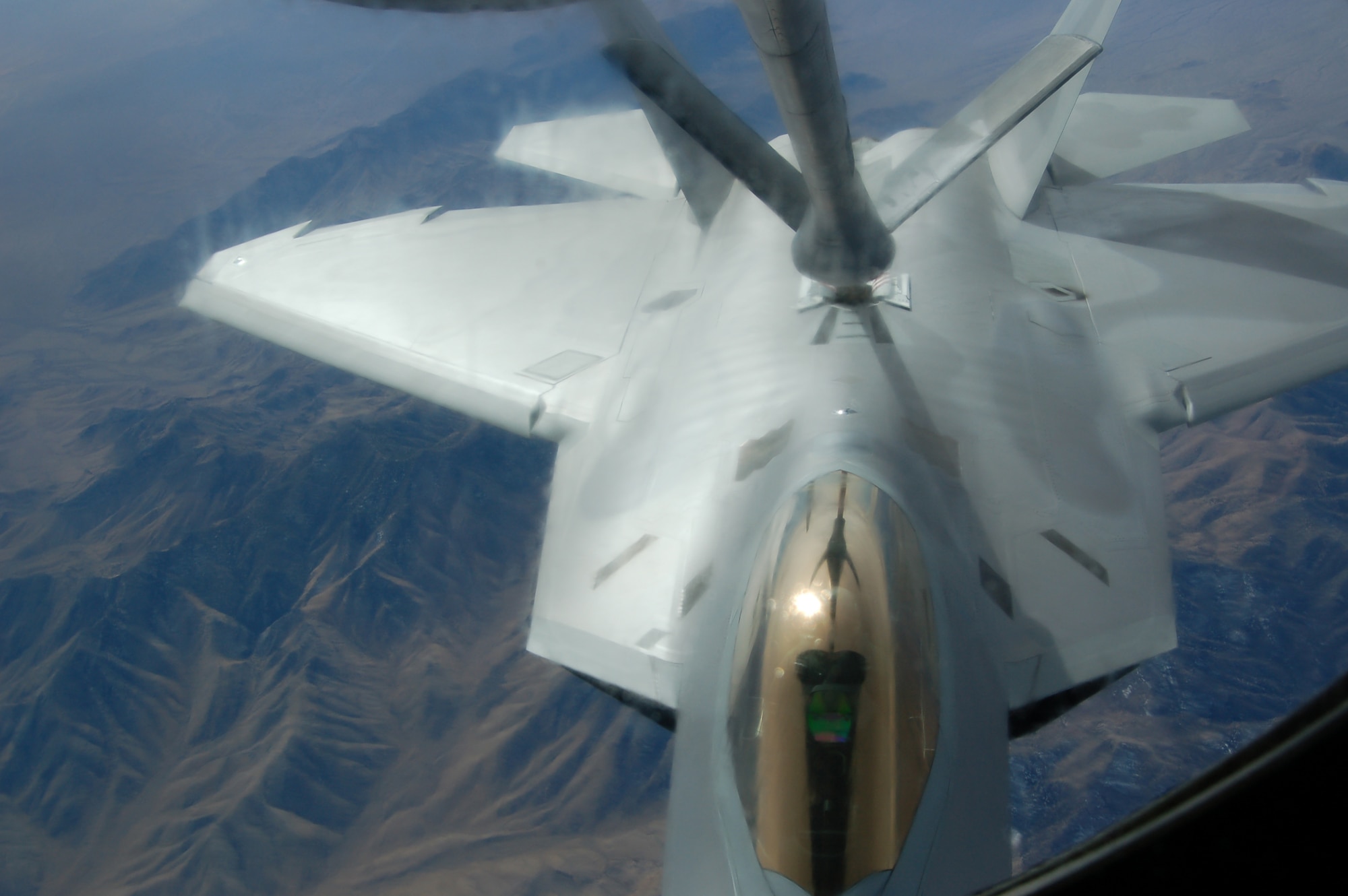 An F-22 Raptor from the 1st Fighter Wing at Langley Air Force Base, Va., tops off from a KC-135 Stratotanker Feb. 7 during the Red Flag Exercise at Nellis AFB, Nev. Two KC-135s from the 319th Air Refueling Wing at Grand Forks Air Force Base, N.D., make up the lead tanker unit during the exercise. (U.S. Air Force photo/1st Lt. Randi Norton)