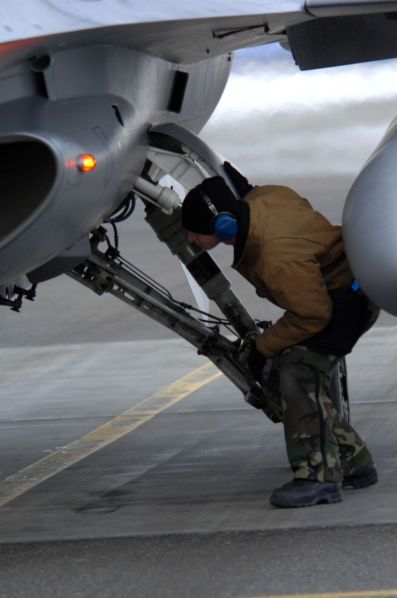 EIELSON AIR FORCE BASE, Alaska -- Senior Airman Joshua McCathern, 354th Aircraft Maintenance Squadron, inspects an F-16C Fighting Falcon as a part of a End of Runway crew here on Feb. 8. The crew is responsible for arming all weapons and making sure the aircraft is ready for flight. The F-16 is assigned to the 18th Fighter Squadron. The 18th Fighter Squadron conducts air operations for combat-ready F-16 aircraft and provides close air support, forward air control (airborne), battlefield air interdiction, and offensive counter air.
(U.S. Air Force Photo by Staff Sgt Joshua Strang)