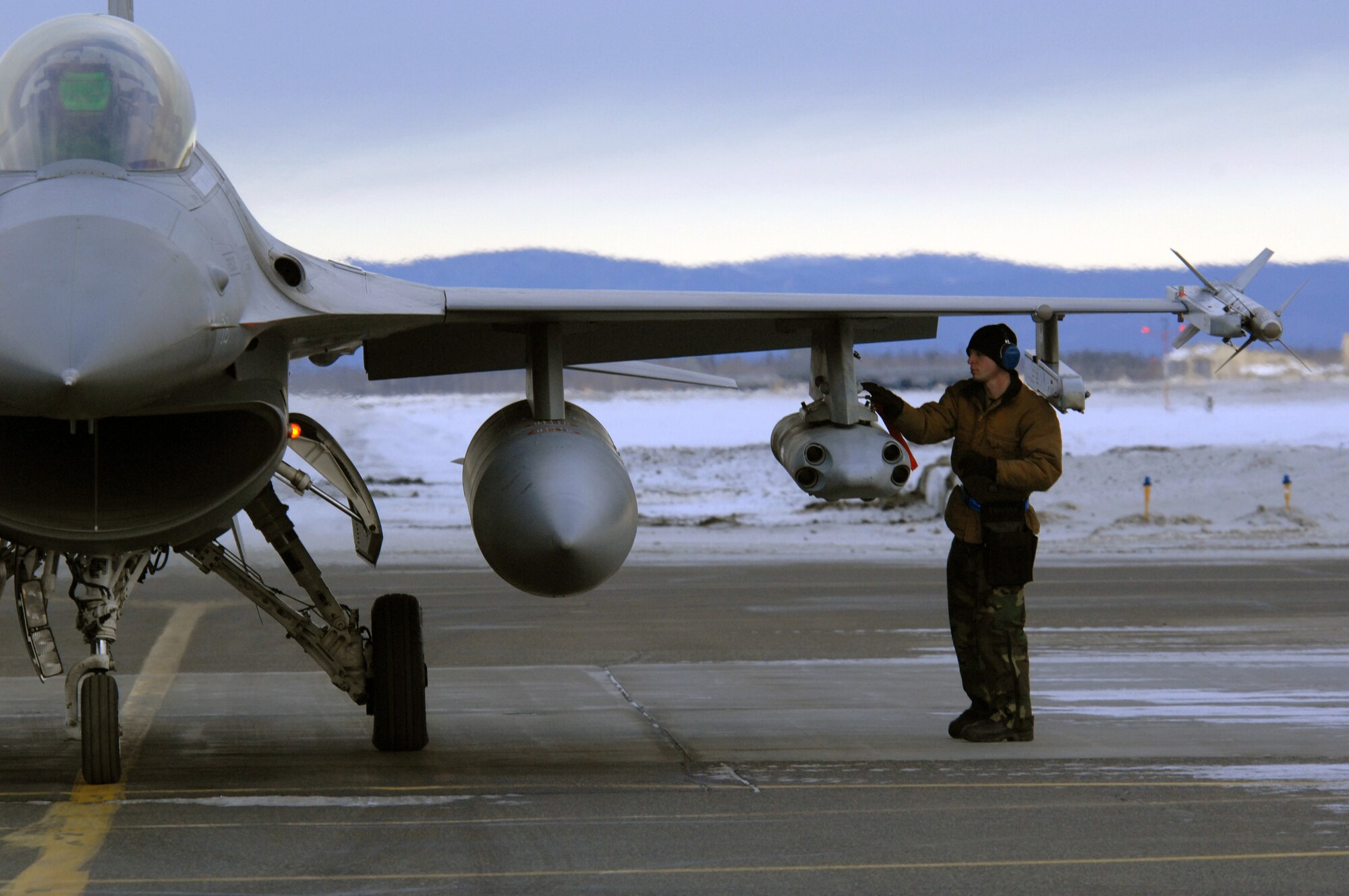 EIELSON AIR FORCE BASE, Alaska -- Senior Airman Joshua McCathern, 354th Aircraft Maintenance Squadron, arms an F-16C Fighting Falcon as a part of a End of Runway crew here on Feb. 8. The crew is responsible for arming all weapons and making sure the aircraft is ready for flight. The F-16 is assigned to the 18th Fighter Squadron. The 18th Fighter Squadron conducts air operations for combat-ready F-16 aircraft and provides close air support, forward air control (airborne), battlefield air interdiction, and offensive counter air.
(U.S. Air Force Photo by Staff Sgt Joshua Strang)