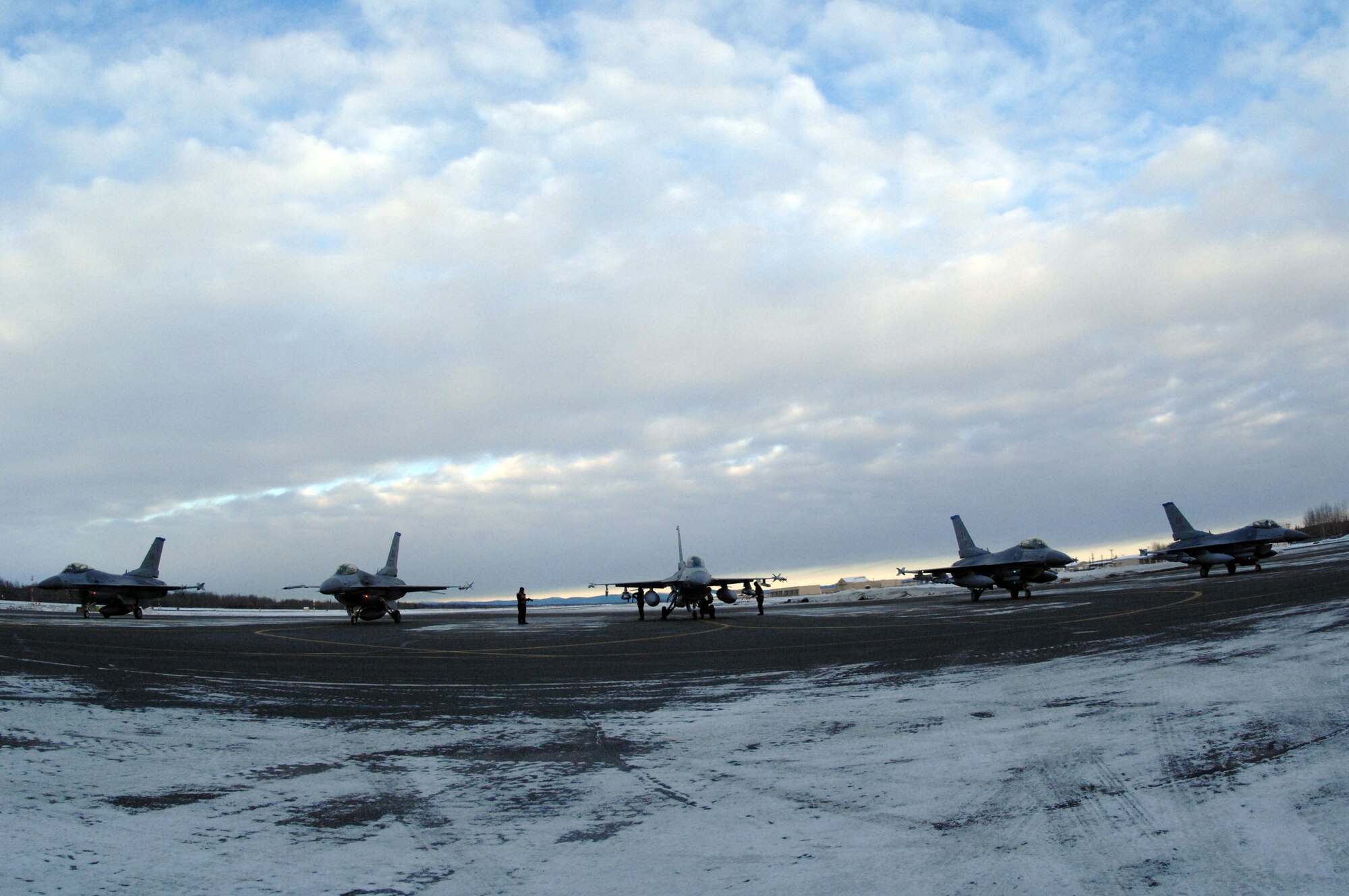 EIELSON AIR FORCE BASE, Alaska -- A 354th Aircraft Maintenance Squadron End of Runway crew arms and inspects five F-16 Fighting Falcon aircraft here on Feb. 8. The crew is responsible for arming all weapons and making sure the aircraft is ready for flight. The F-16's are assigned to the 18th Fighter Squadron. The 18th Fighter Squadron conducts air operations for combat-ready F-16 aircraft and provides close air support, forward air control (airborne), battlefield air interdiction, and offensive counter air.
(U.S. Air Force Photo by Staff Sgt Joshua Strang)